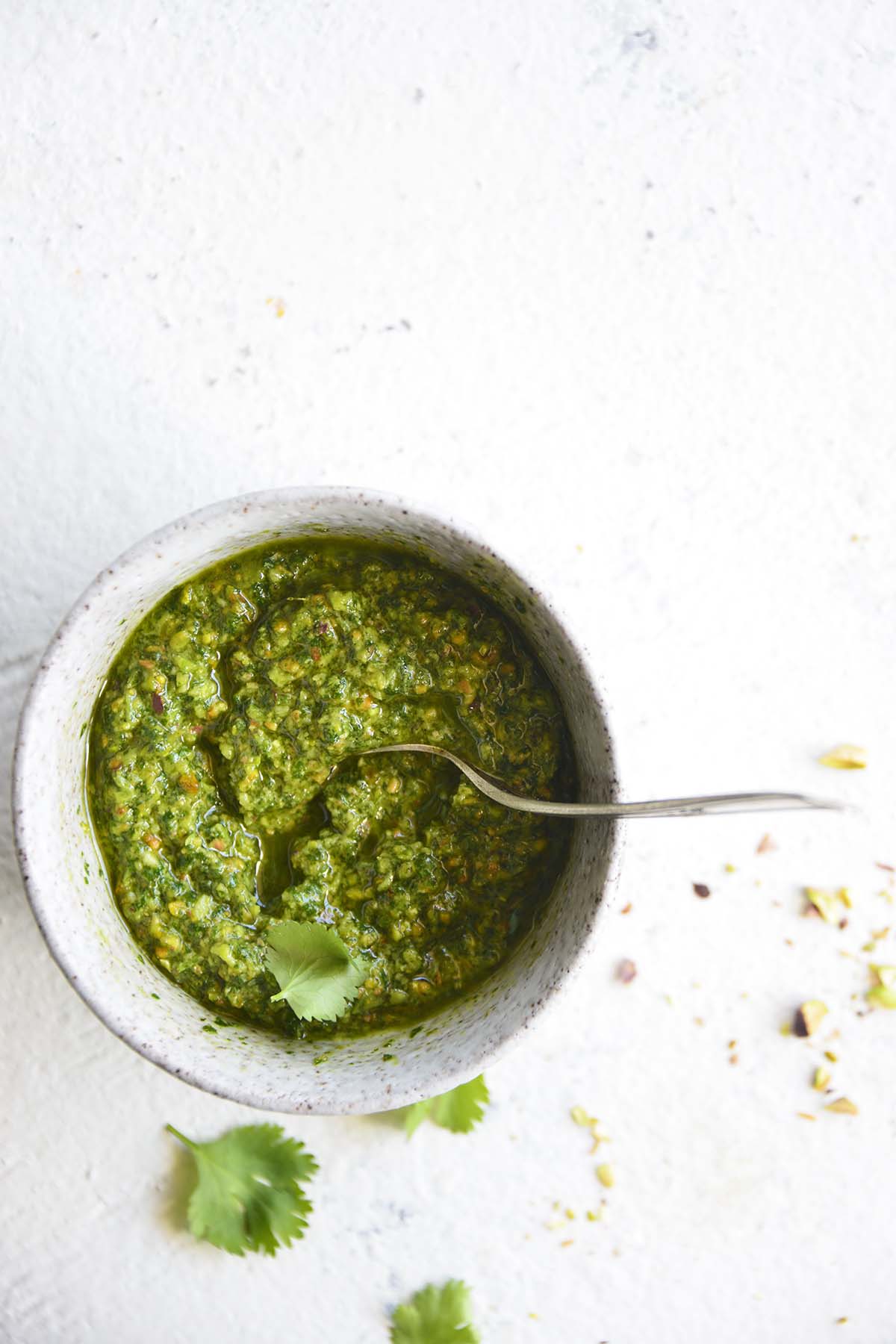 top view of cilantro pesto in stoneware bowl