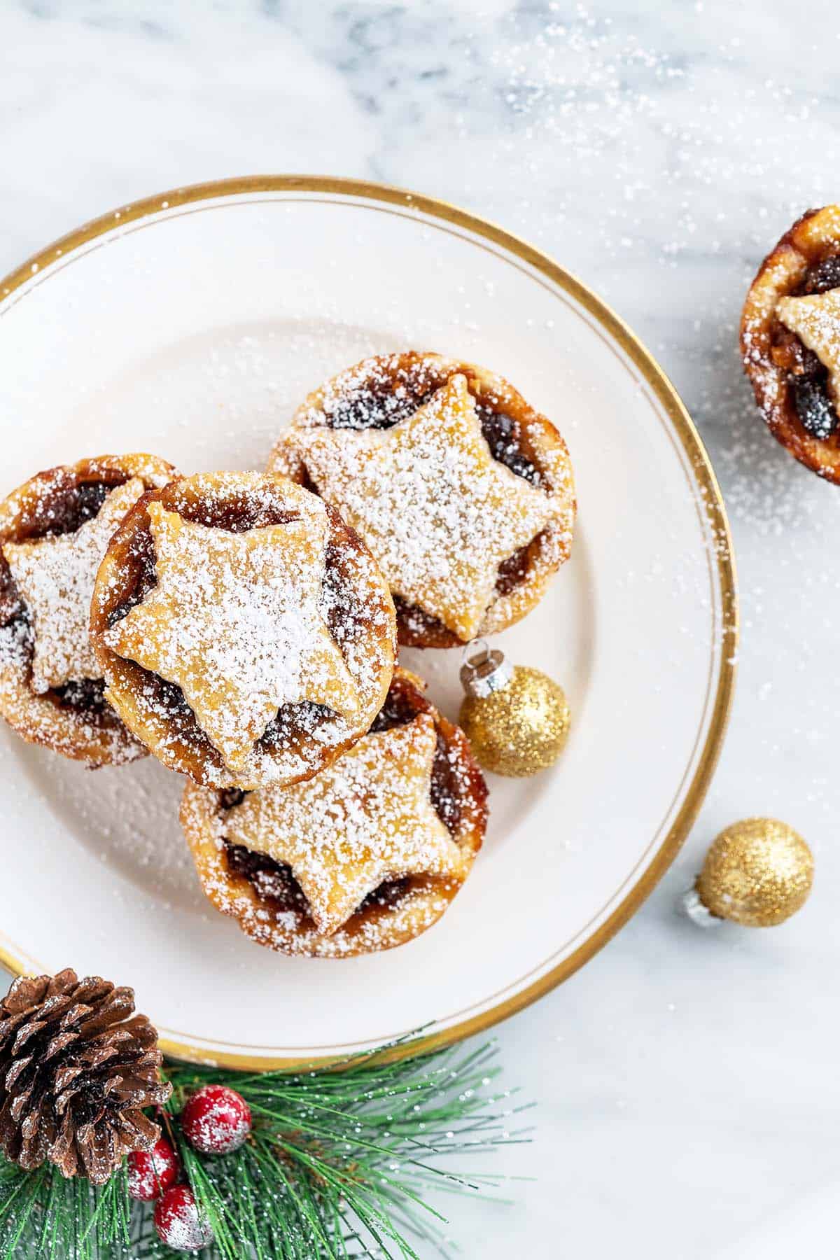 top view of mince tarts on plate with gold rim