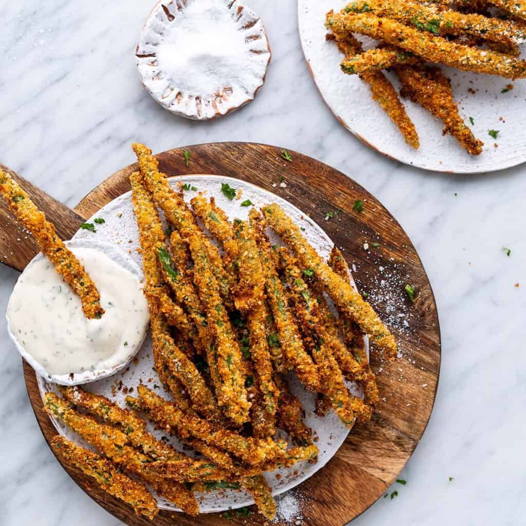 air fryer green bean fries on white plate on top of wooden board featured image