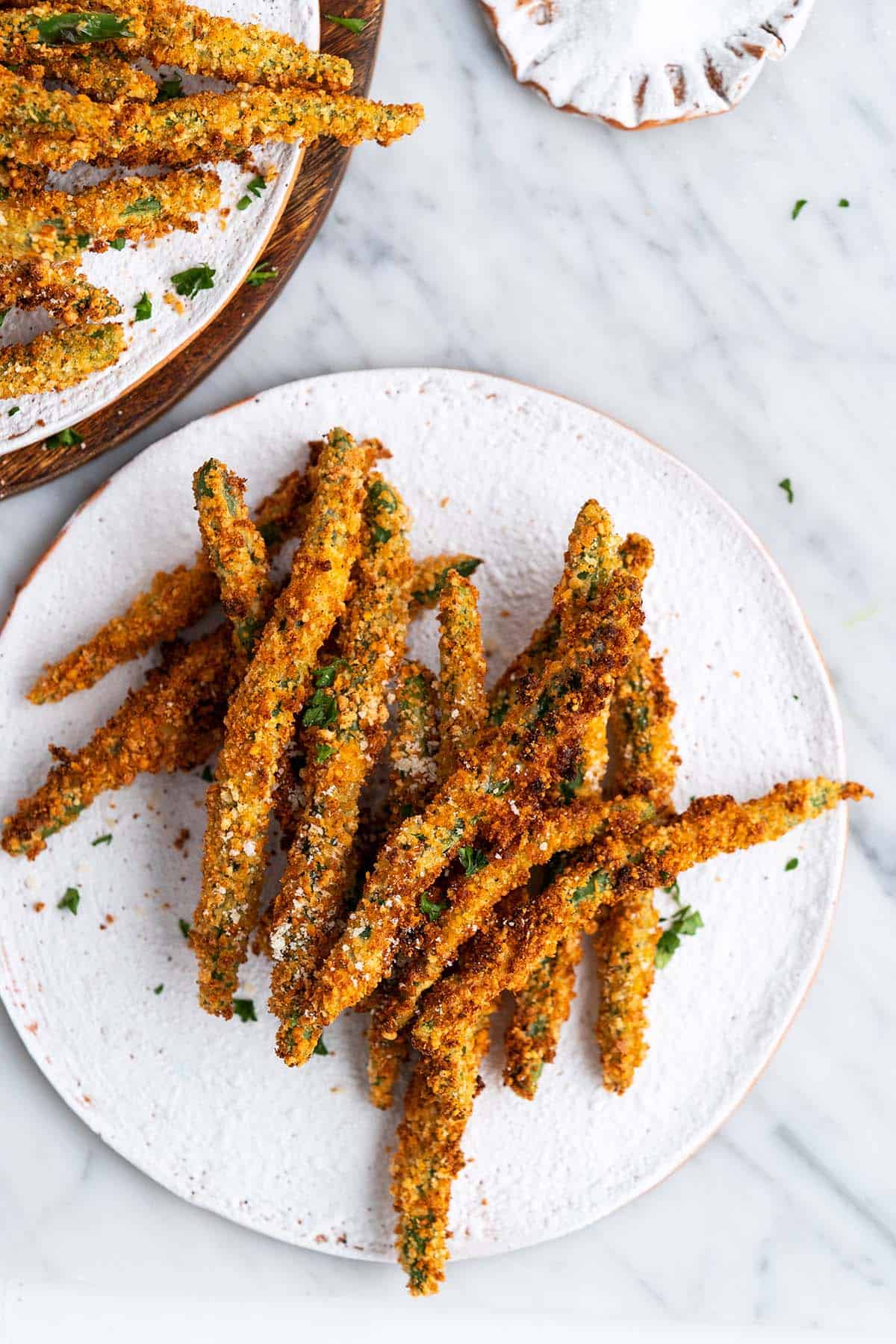 air fryer green bean fries on white stoneware plate