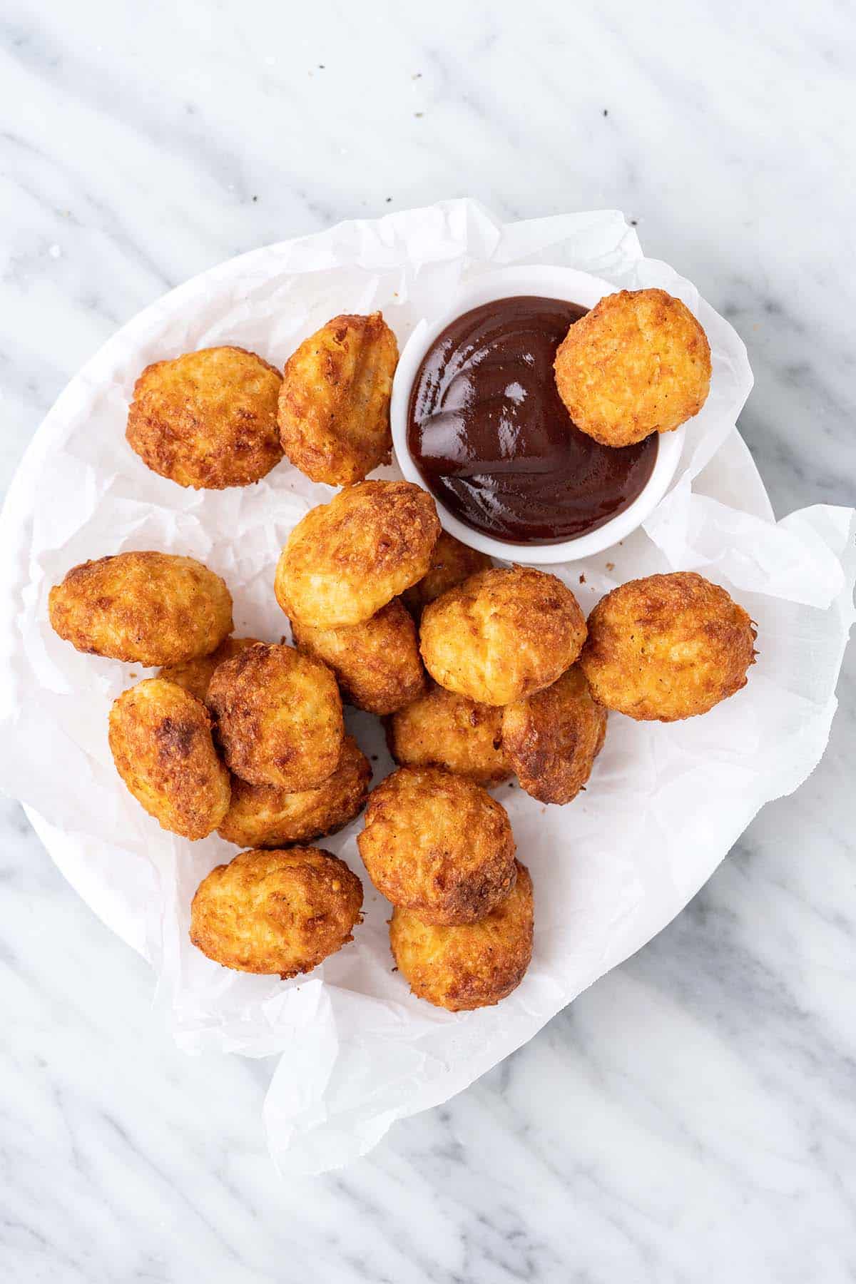 chicken nuggets on plate with bbq sauce
