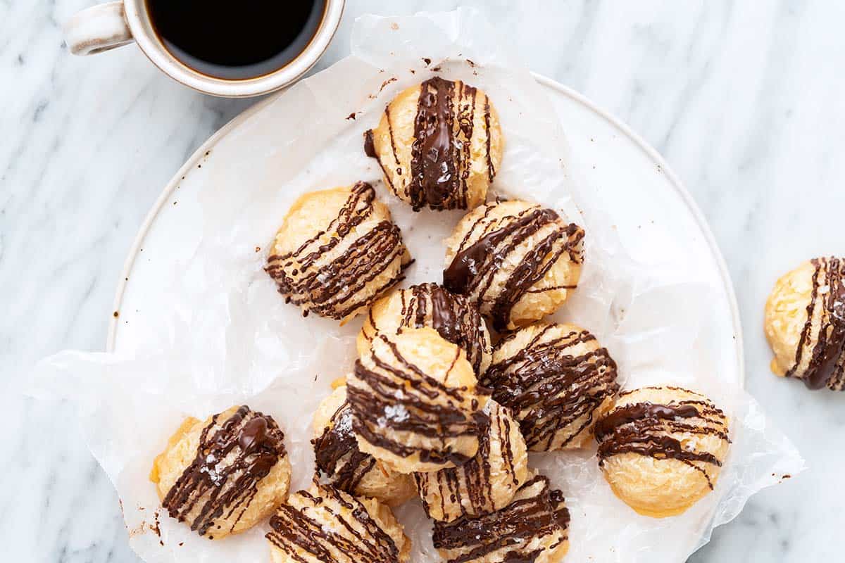 chocolate coconut macaroons on plate with cup of espresso