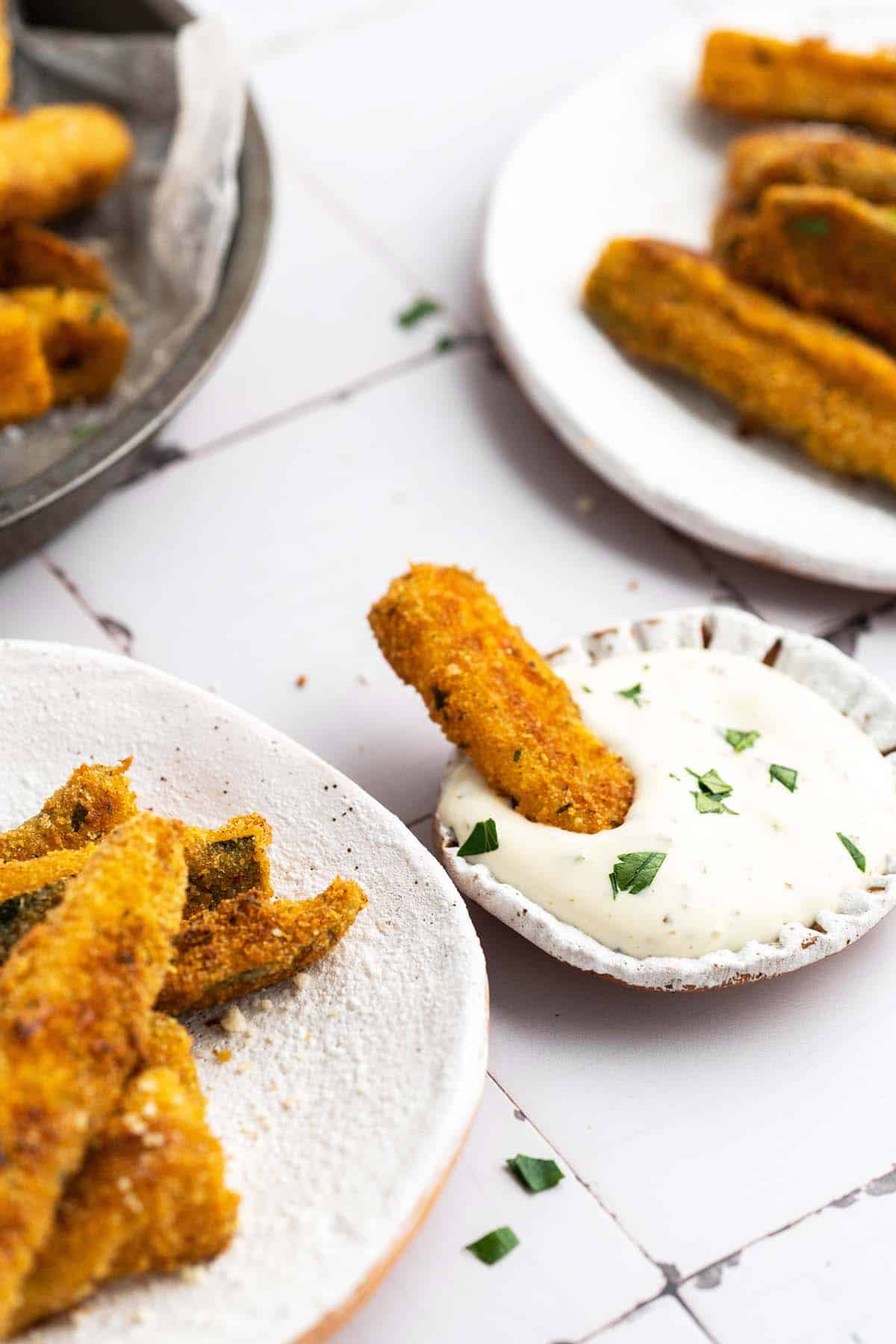 dipping baked zucchini sticks into ranch dressing