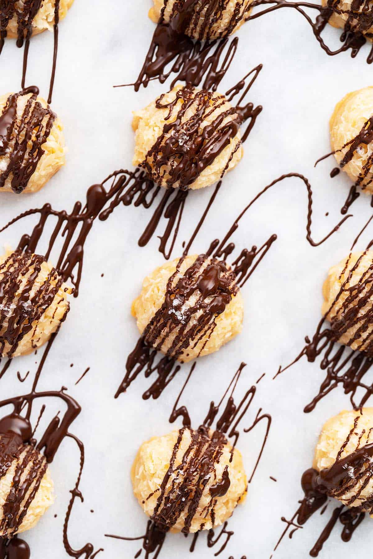 drizzling dark chocolate on chewy coconut macaroons