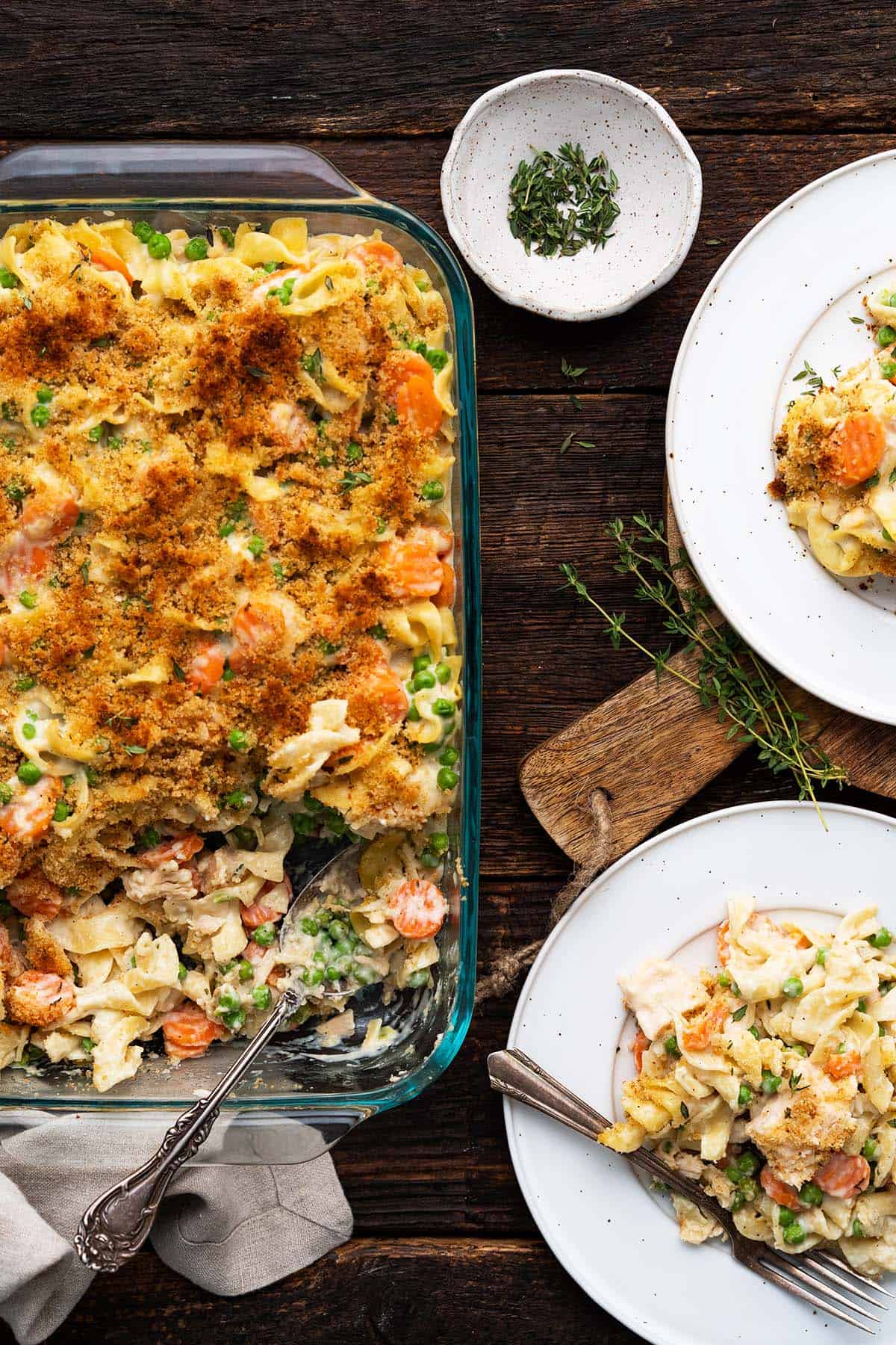 easy chicken noodle casserole in baking dish with serving plates