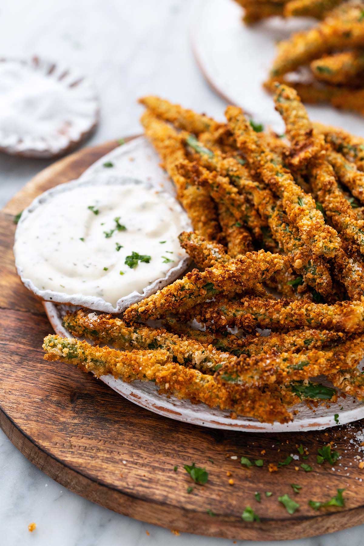 front view of plate of air fryer green bean fries with homemade ranch dressing