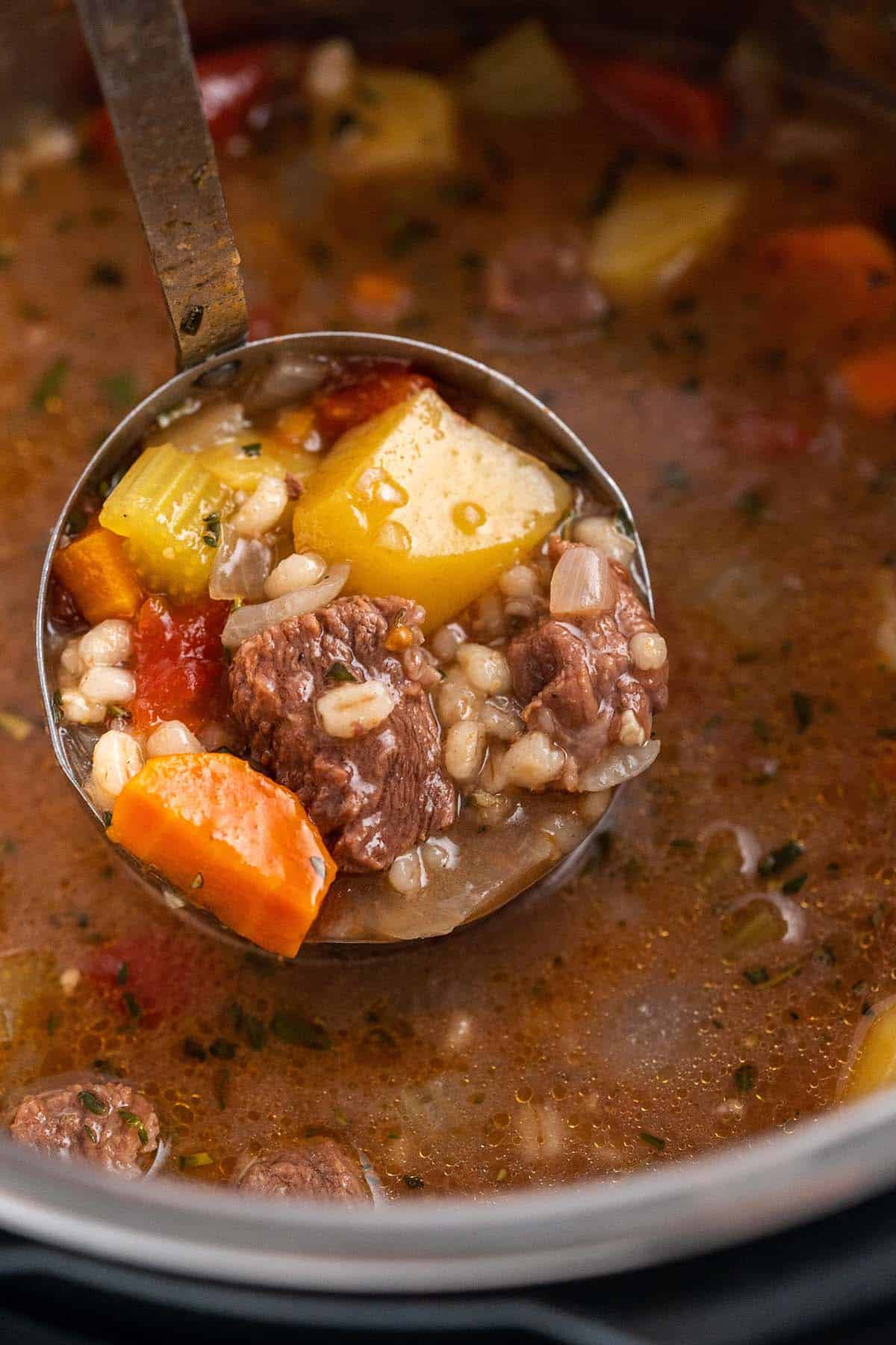 ladle of beef barley soup in instant pot