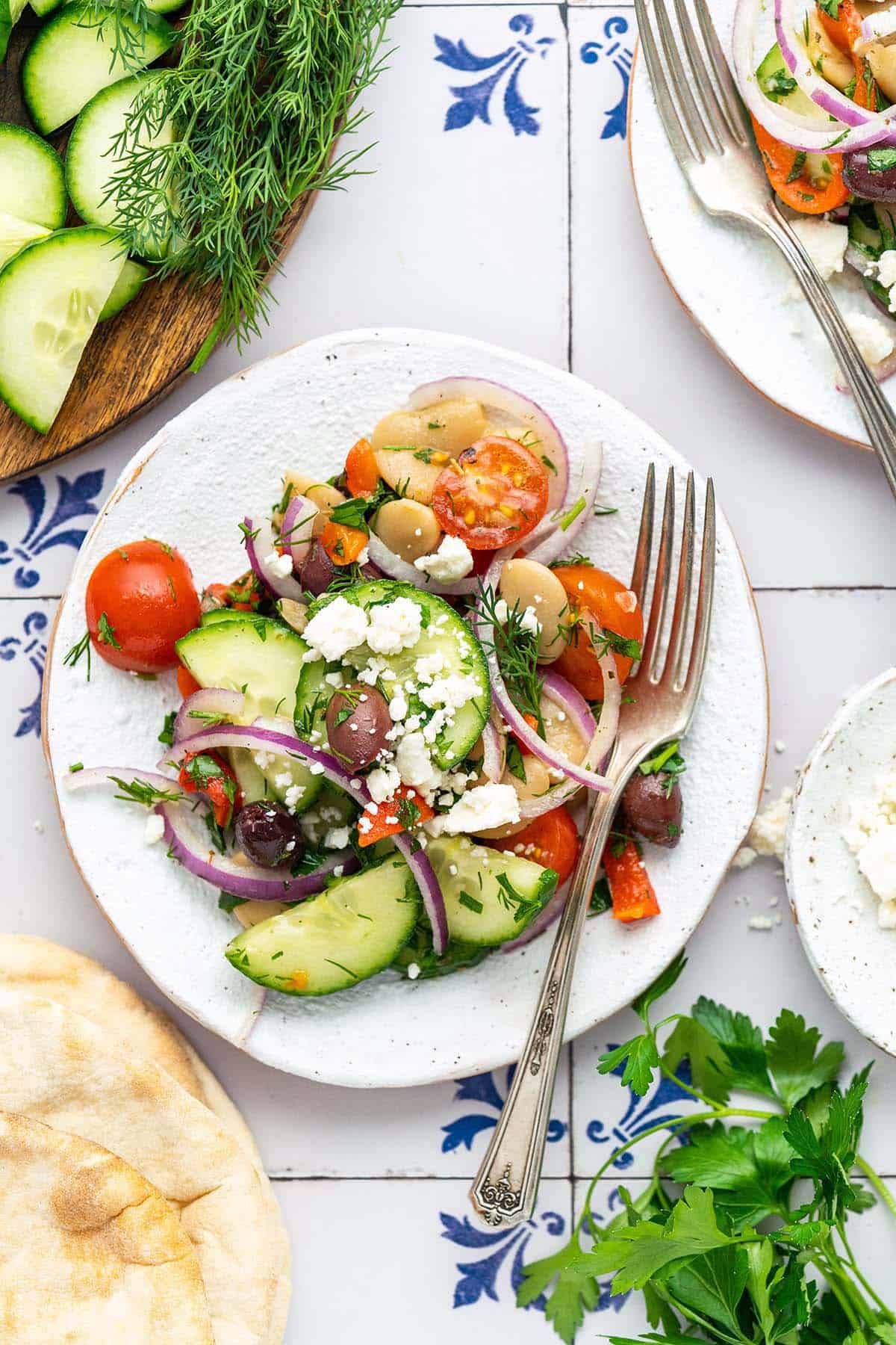 overhead view of mediterranean butter bean salad on rustic white plate