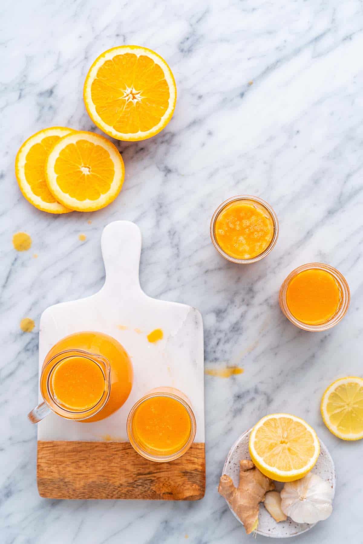 overhead view of wellness shots on marble countertop