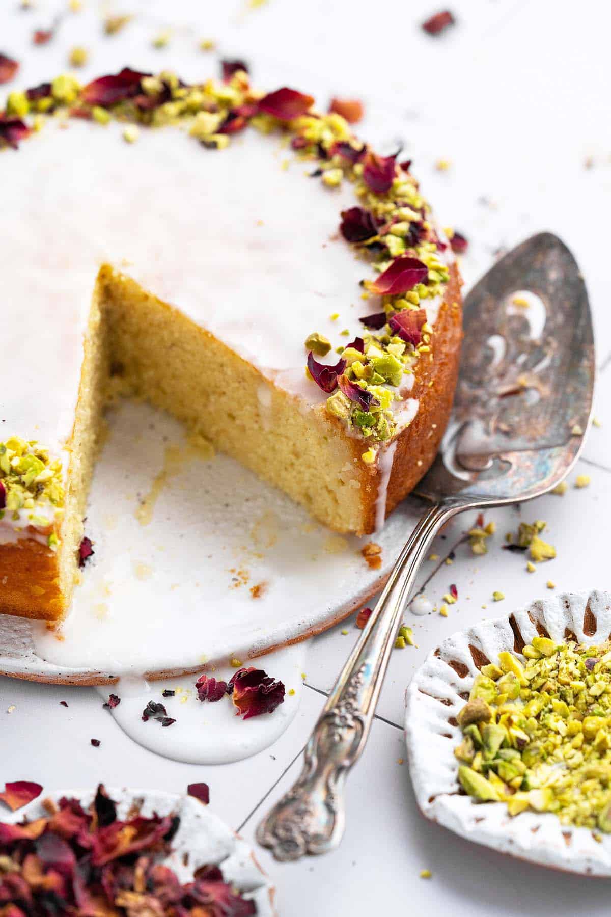 persian love cake on stoneware plate with slice removed