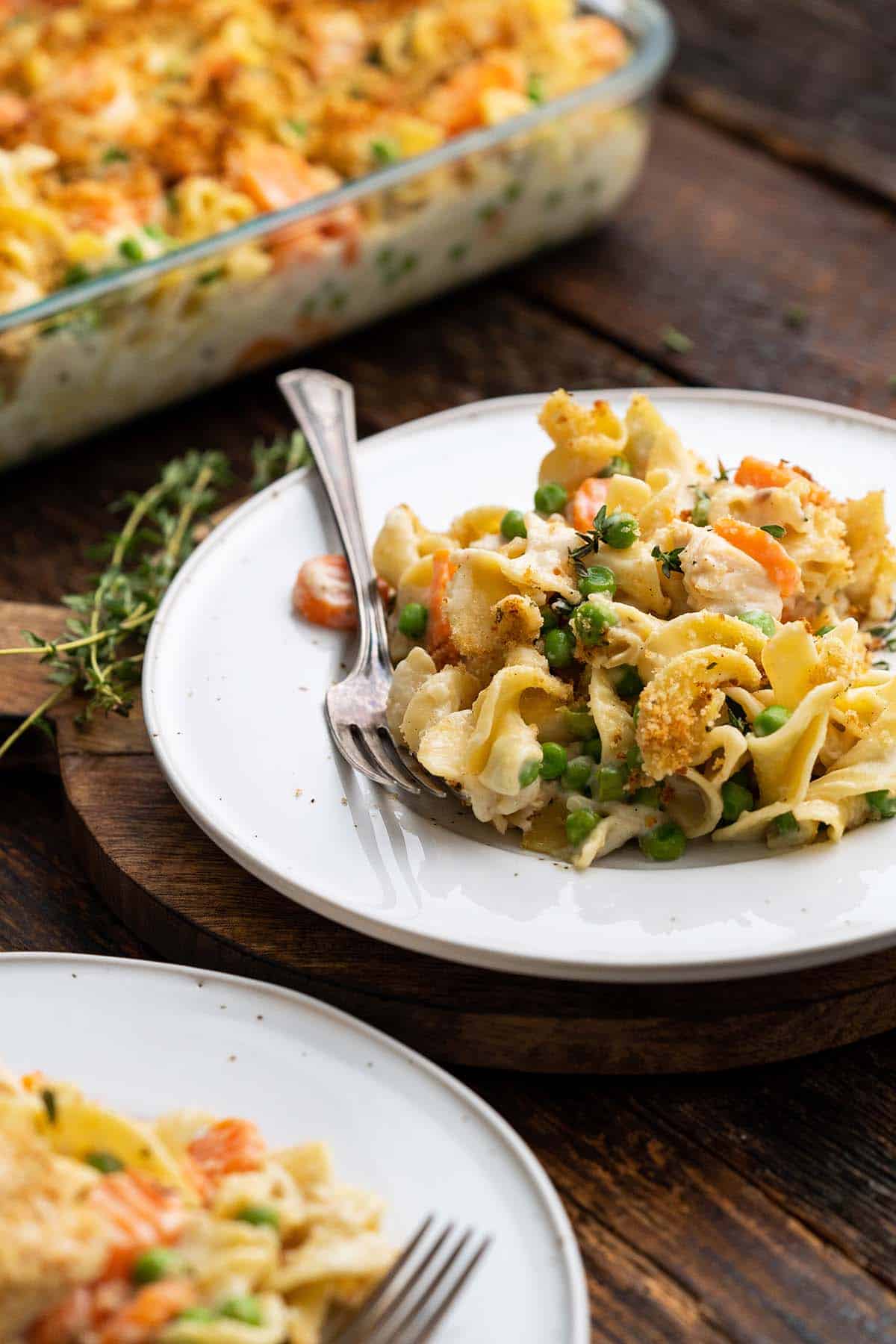 plate of chicken noodle casserole with baking dish in background