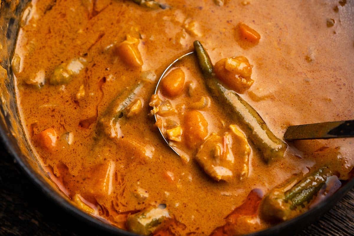 pot of gambian peanut stew with ladle