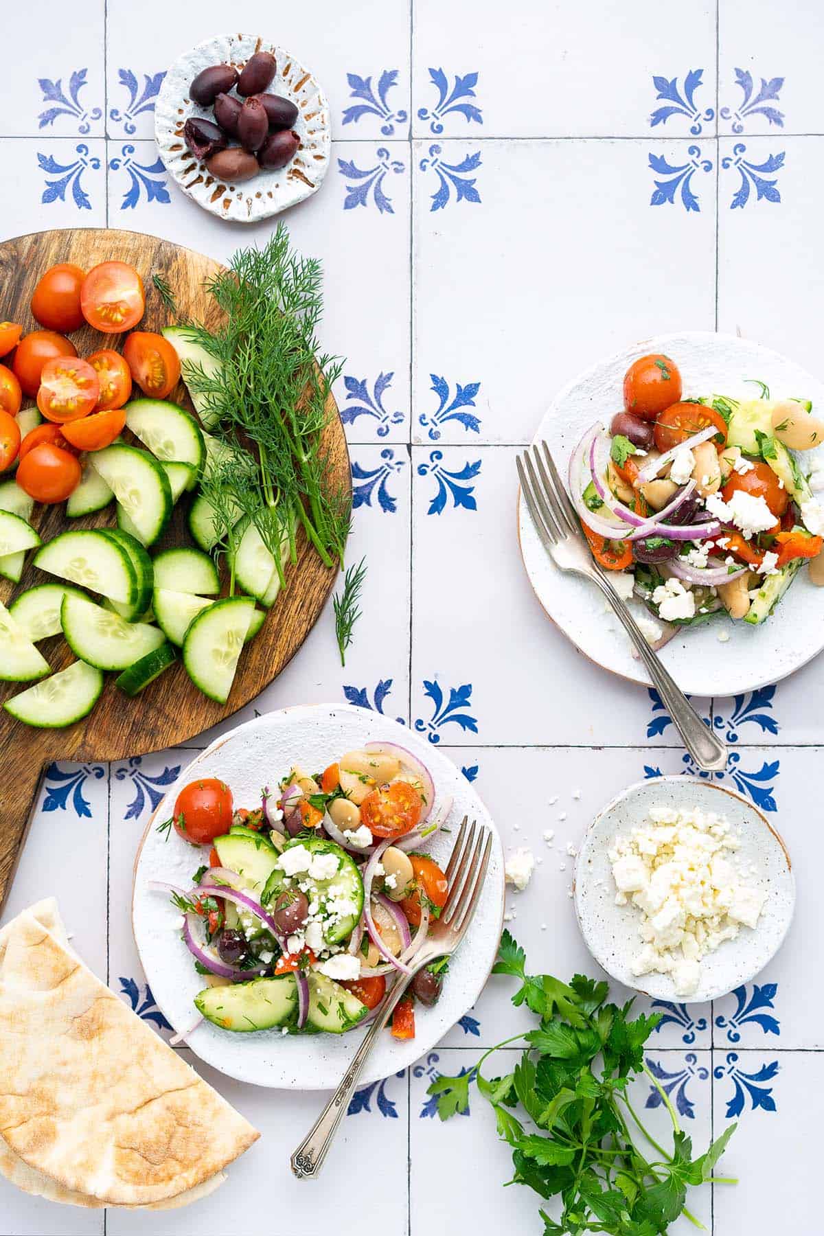 spread of bean salad on plates with pita bread