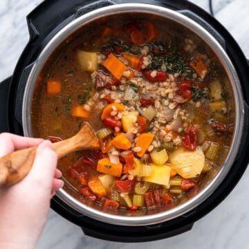 stirring beef barley soup cooked in instant pot with hand stirring
