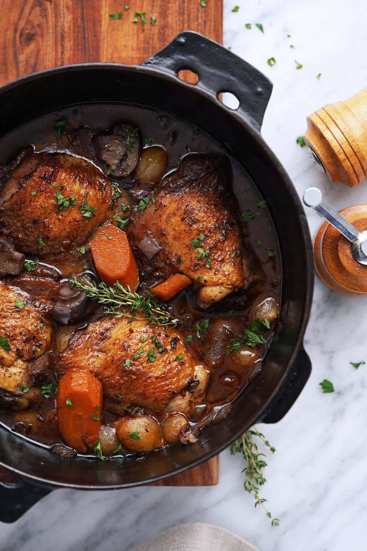 top view of french chicken in red wine in pot