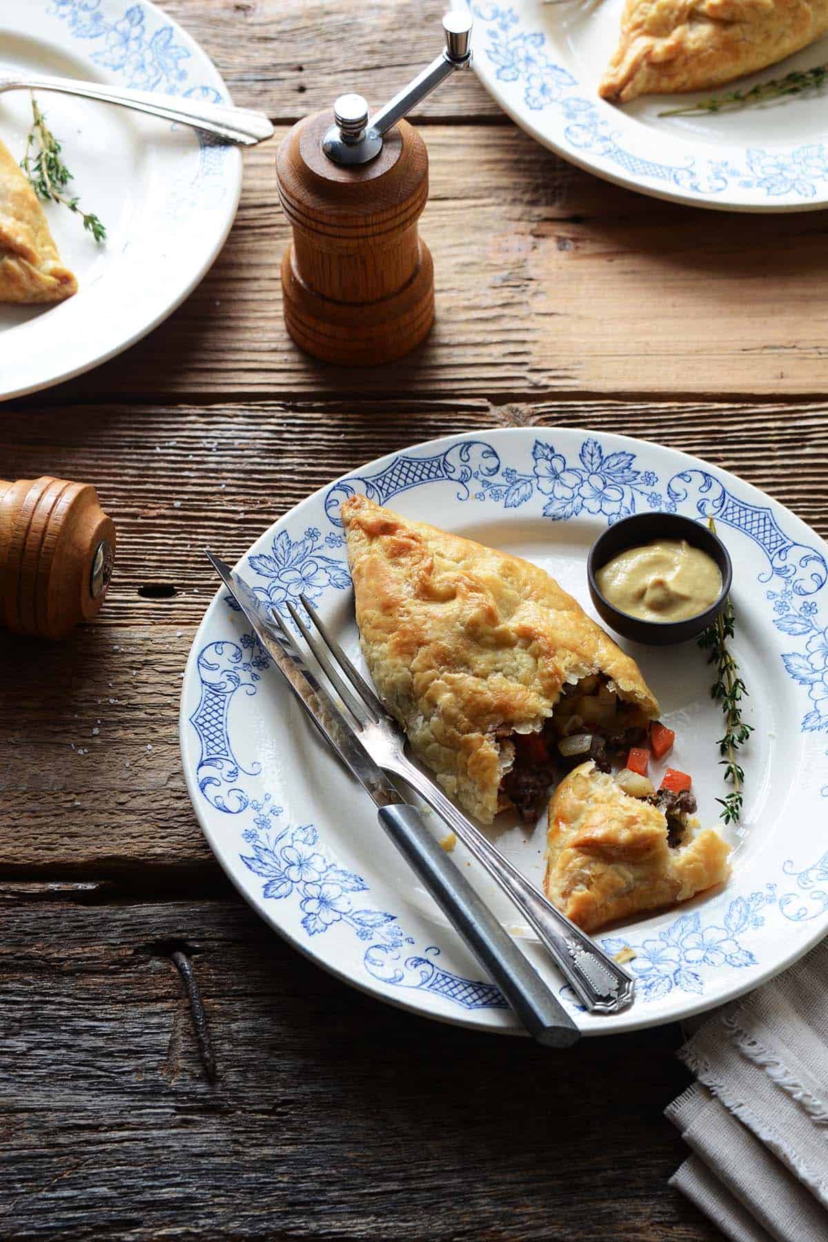 cornish pasty on plate with fork and knife