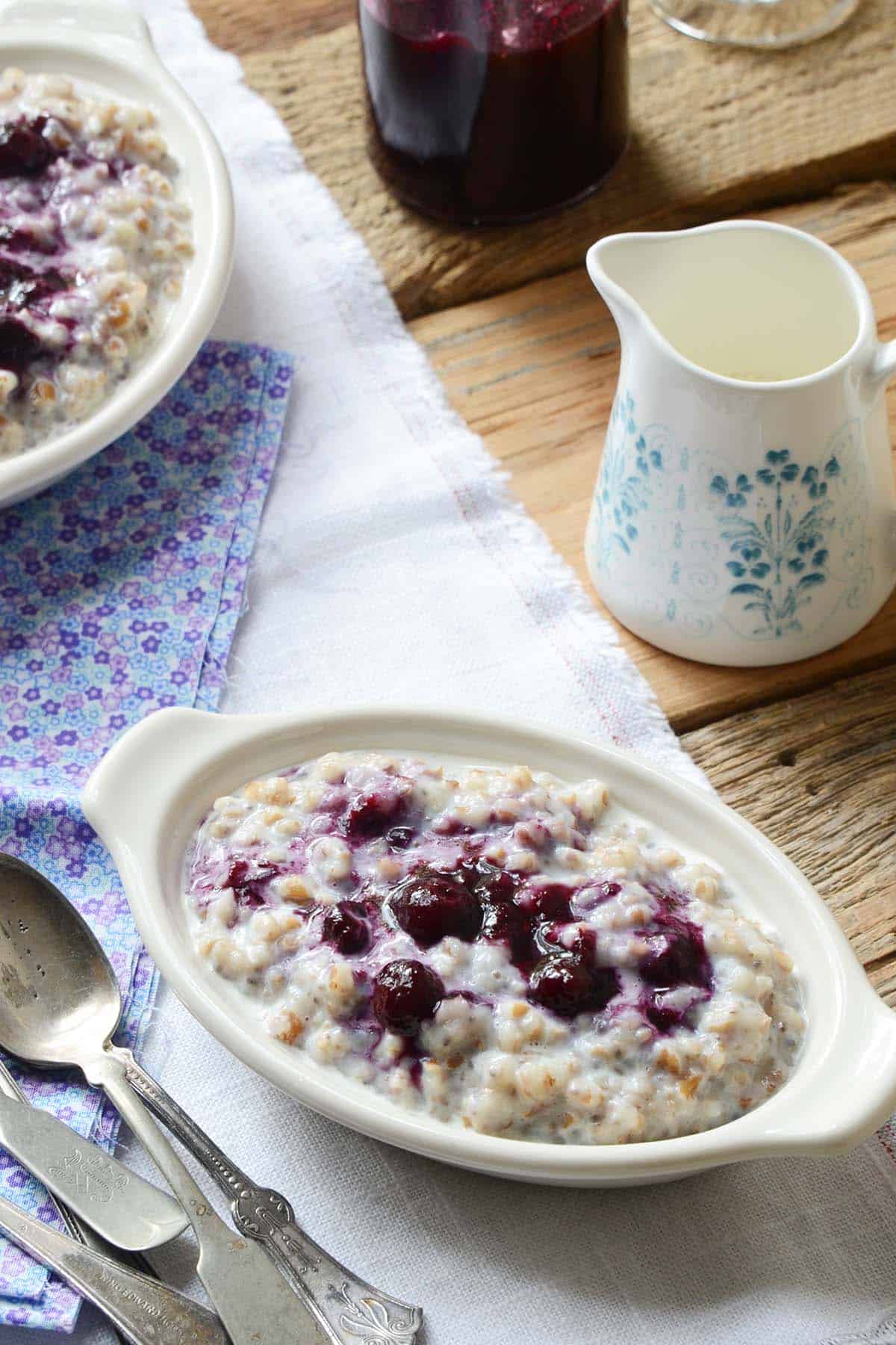 dish of creamy vegan porridge with blueberry sauce