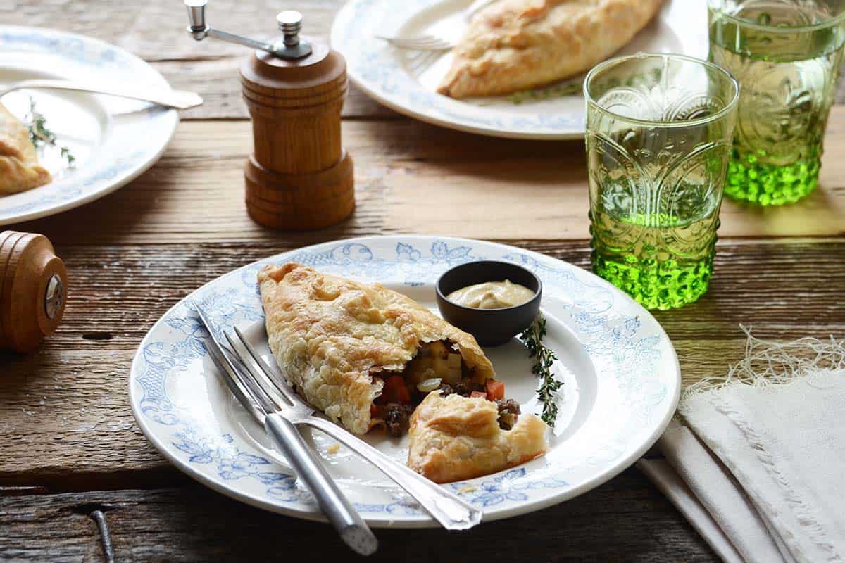 meat pasty on plate on rustic wooden table