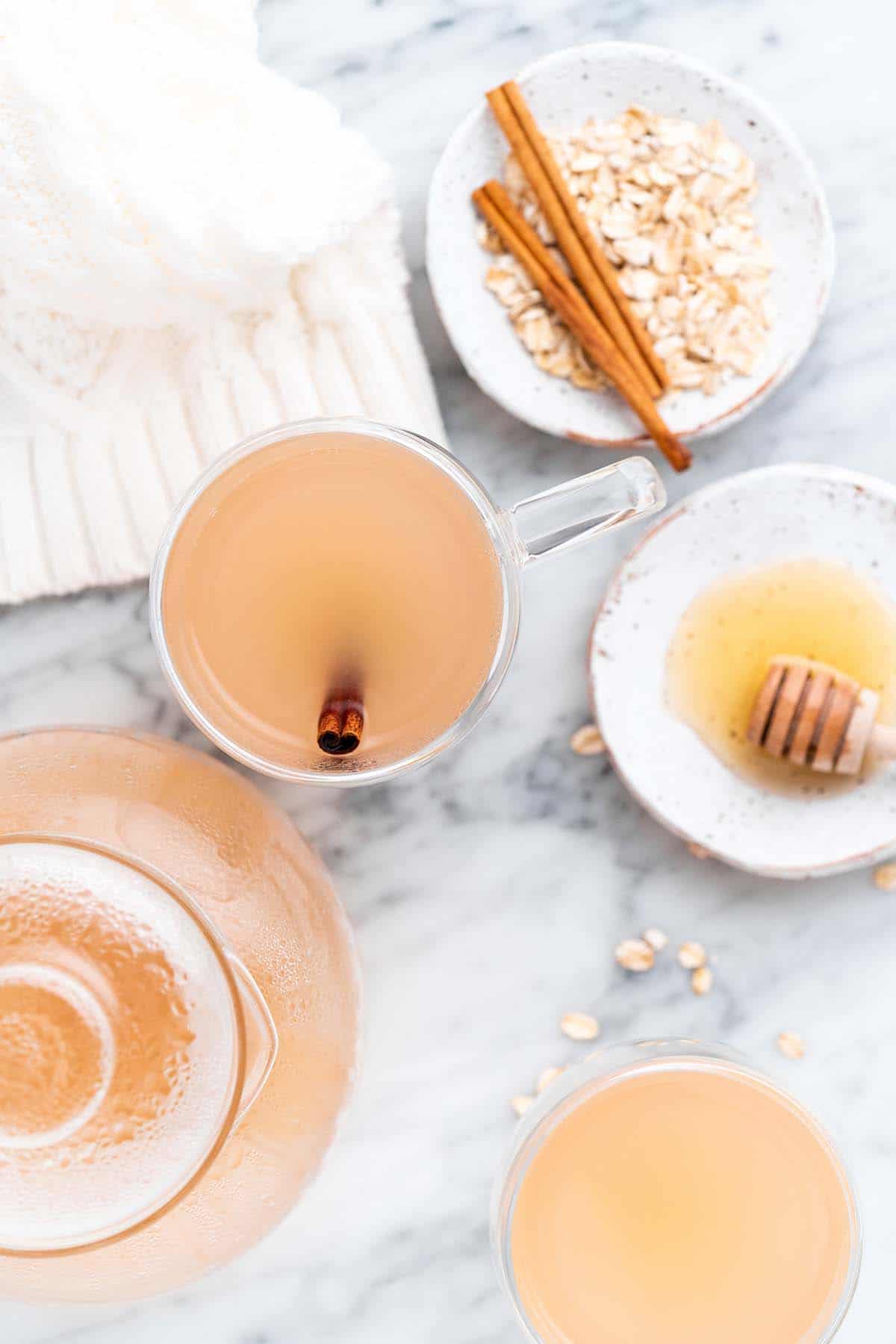 top view of oat tea with dish of oats on marble countertop