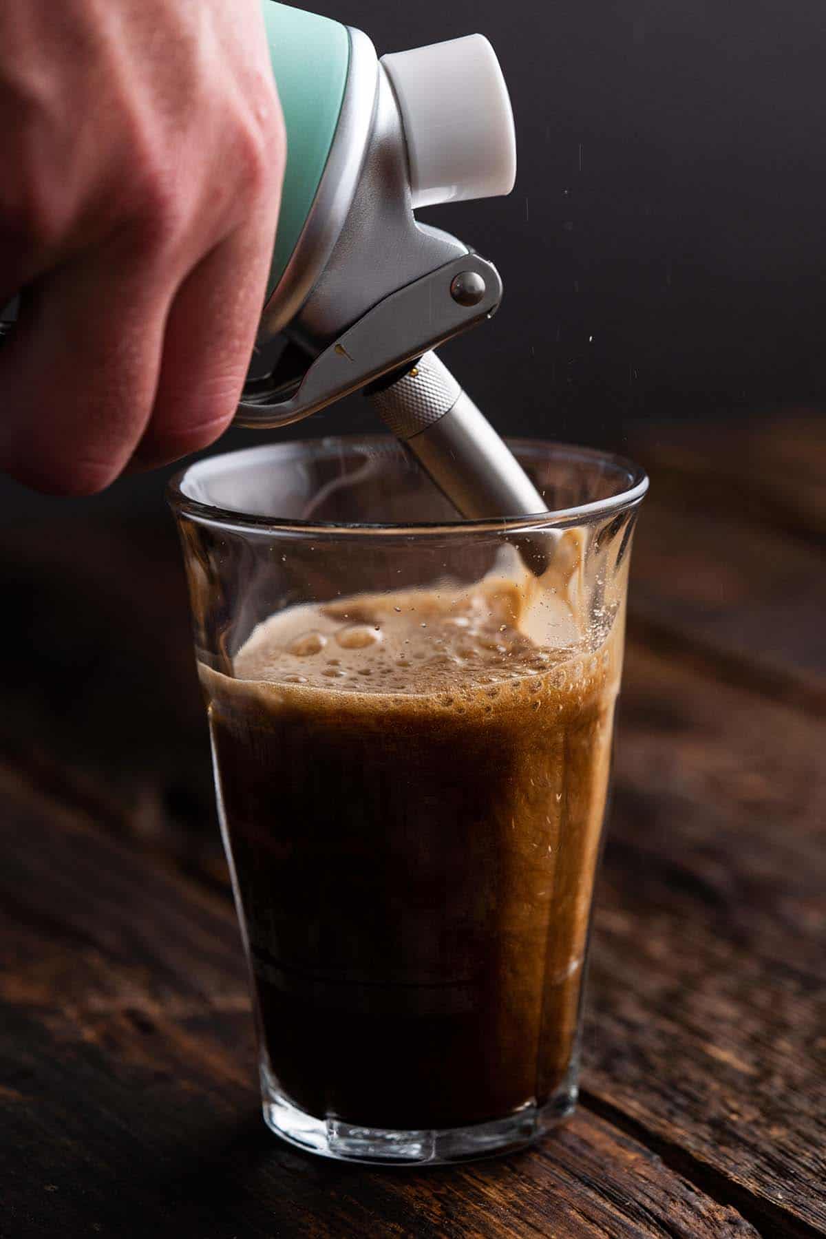 dispensing nitro cold brew coffee into glass
