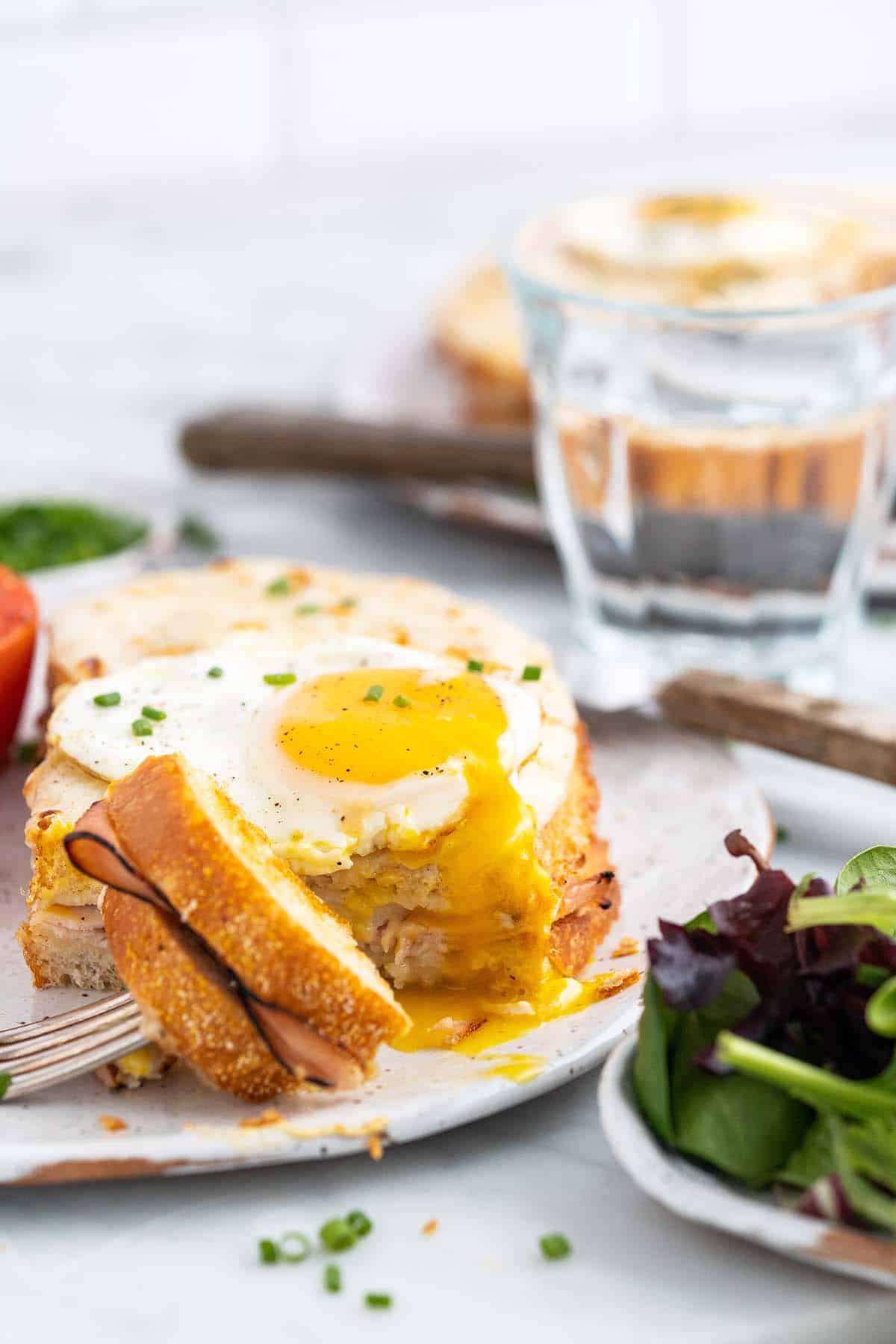 front view of croque madame with runny fried egg on top