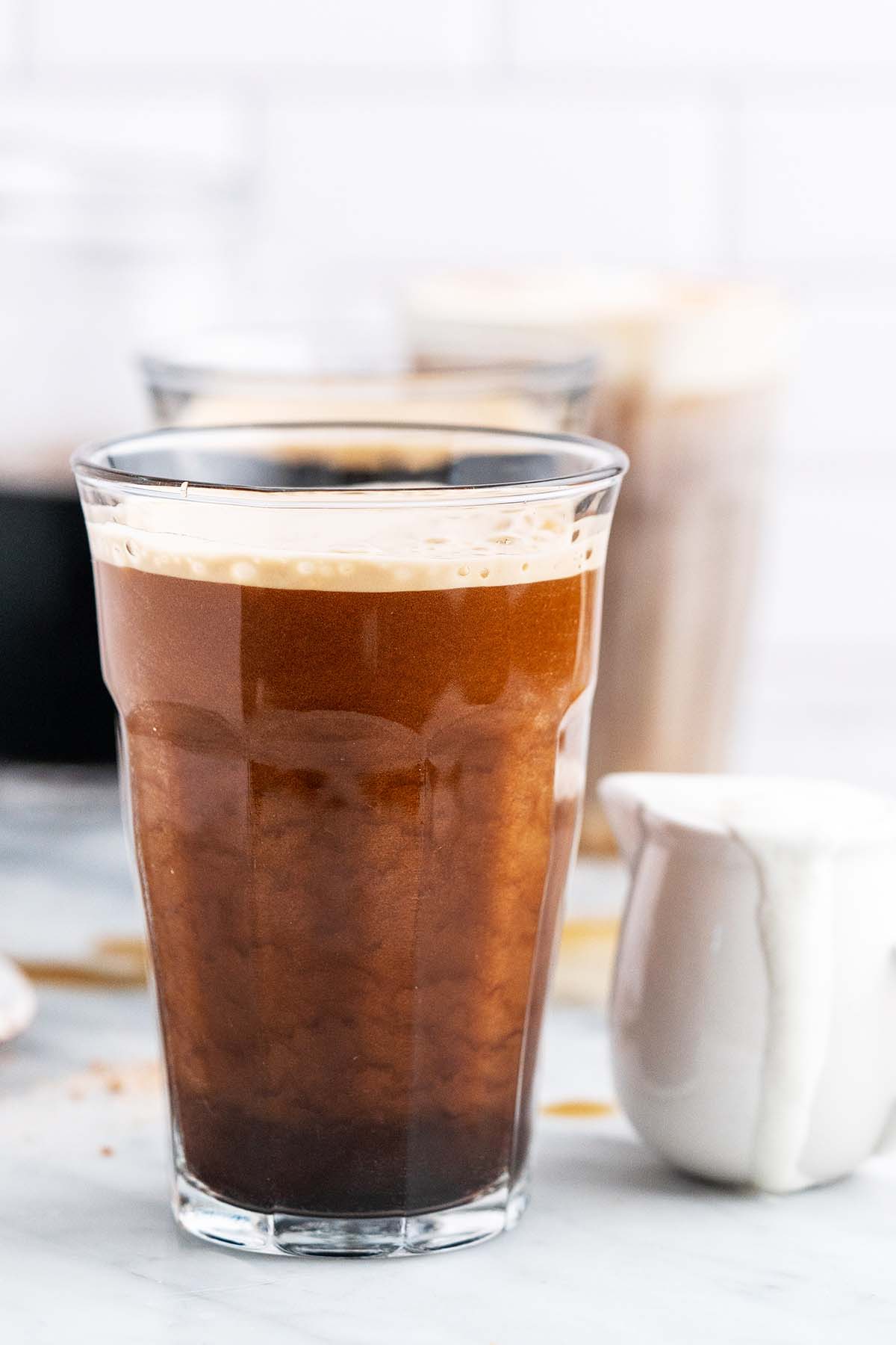 glass of nitro coffee with cascading microbubbles