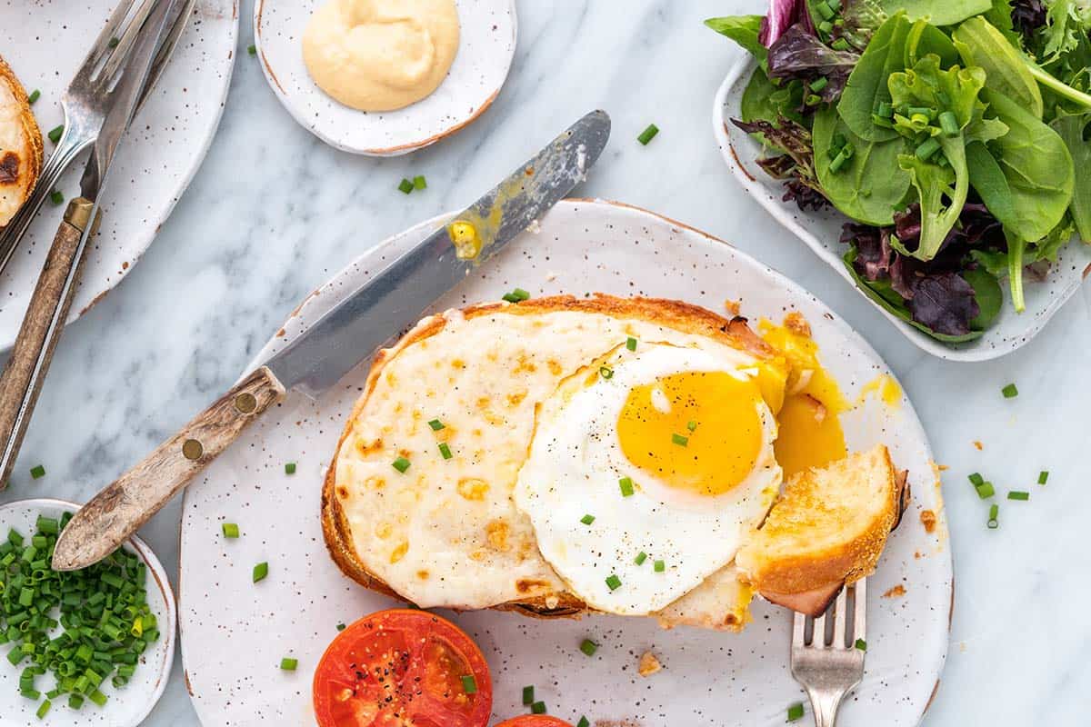 partially eaten croque monsieur with egg