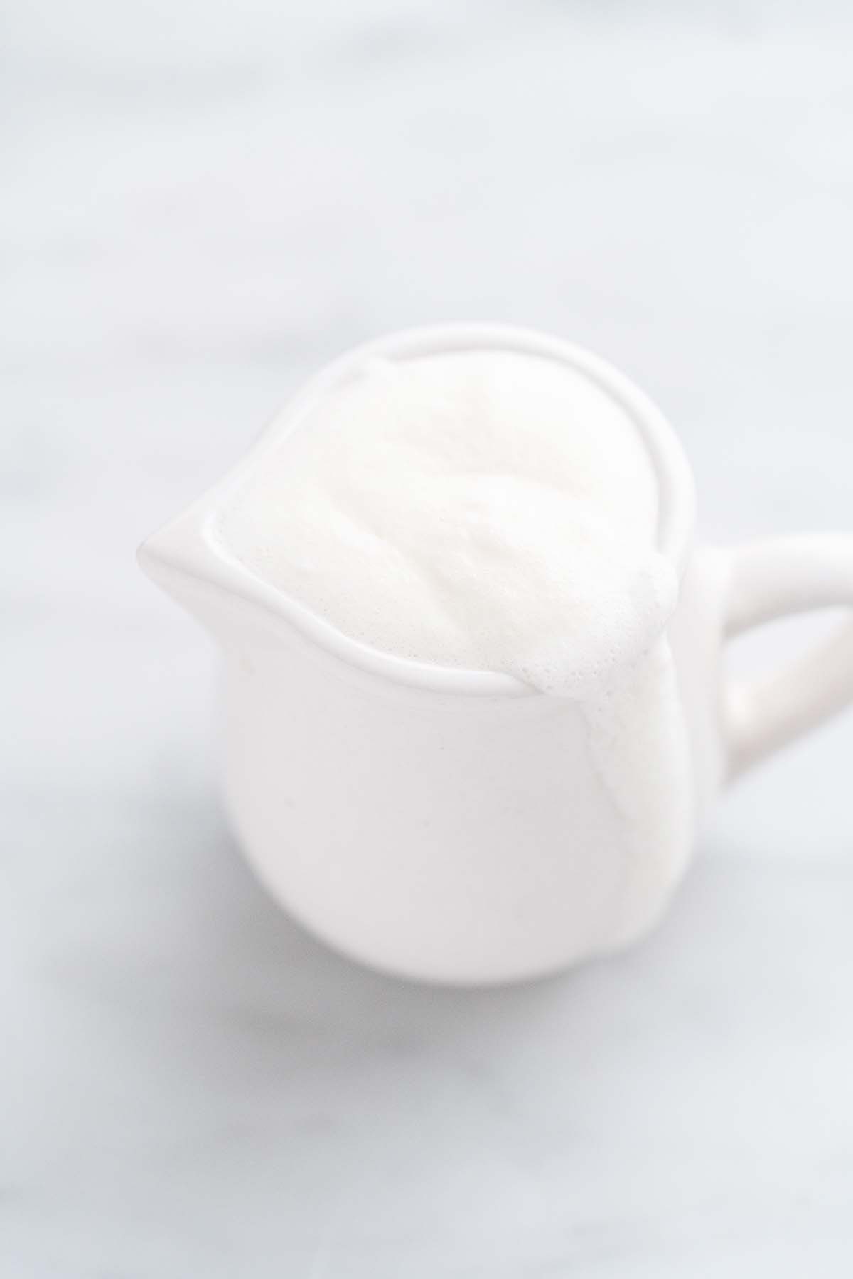 vanilla cream sweet cold foam in small white pitcher
