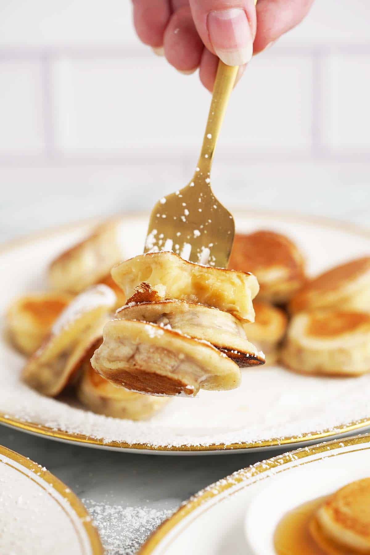 hand holding fork with banana pancake bites