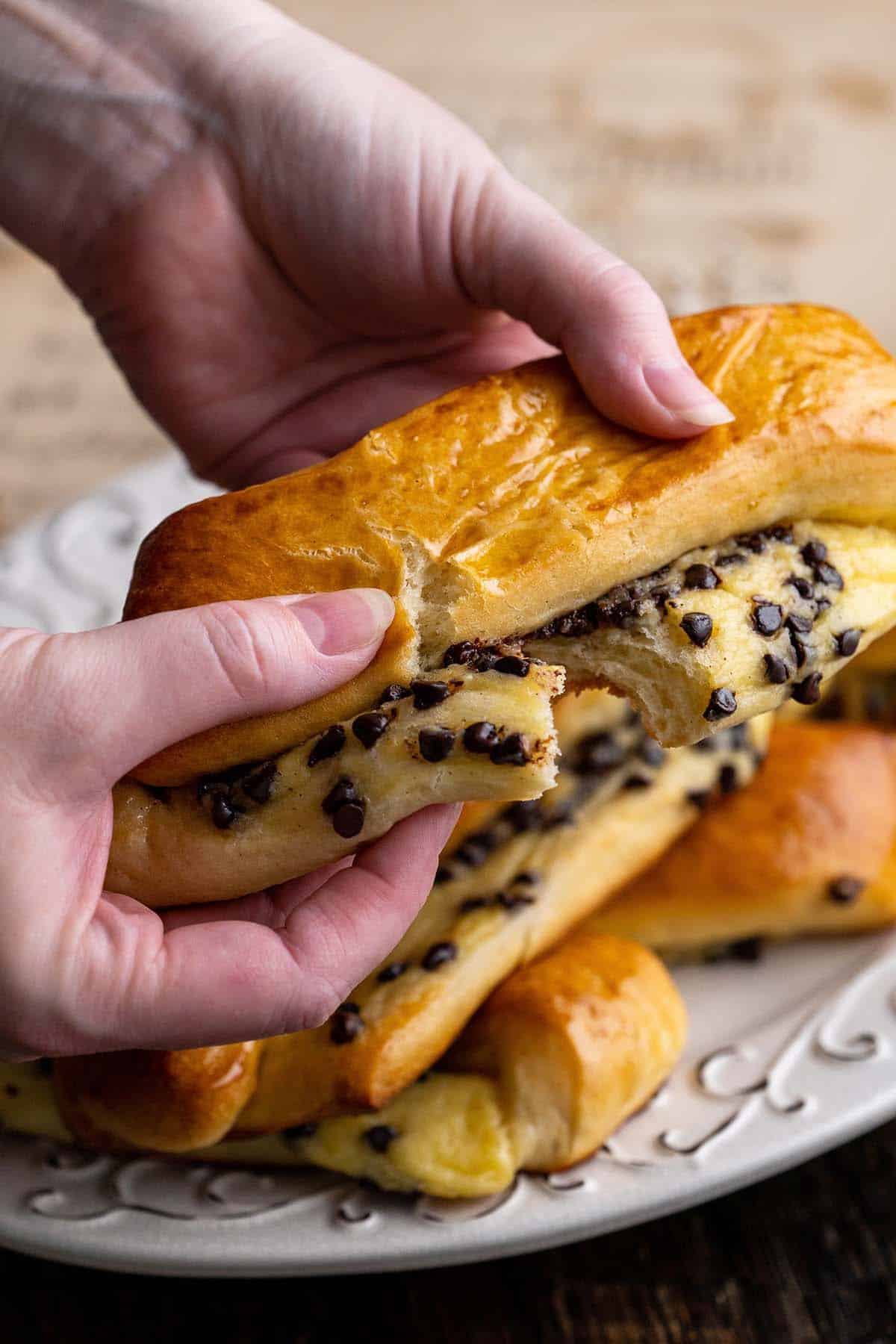 hands breaking into swiss brioche pastry