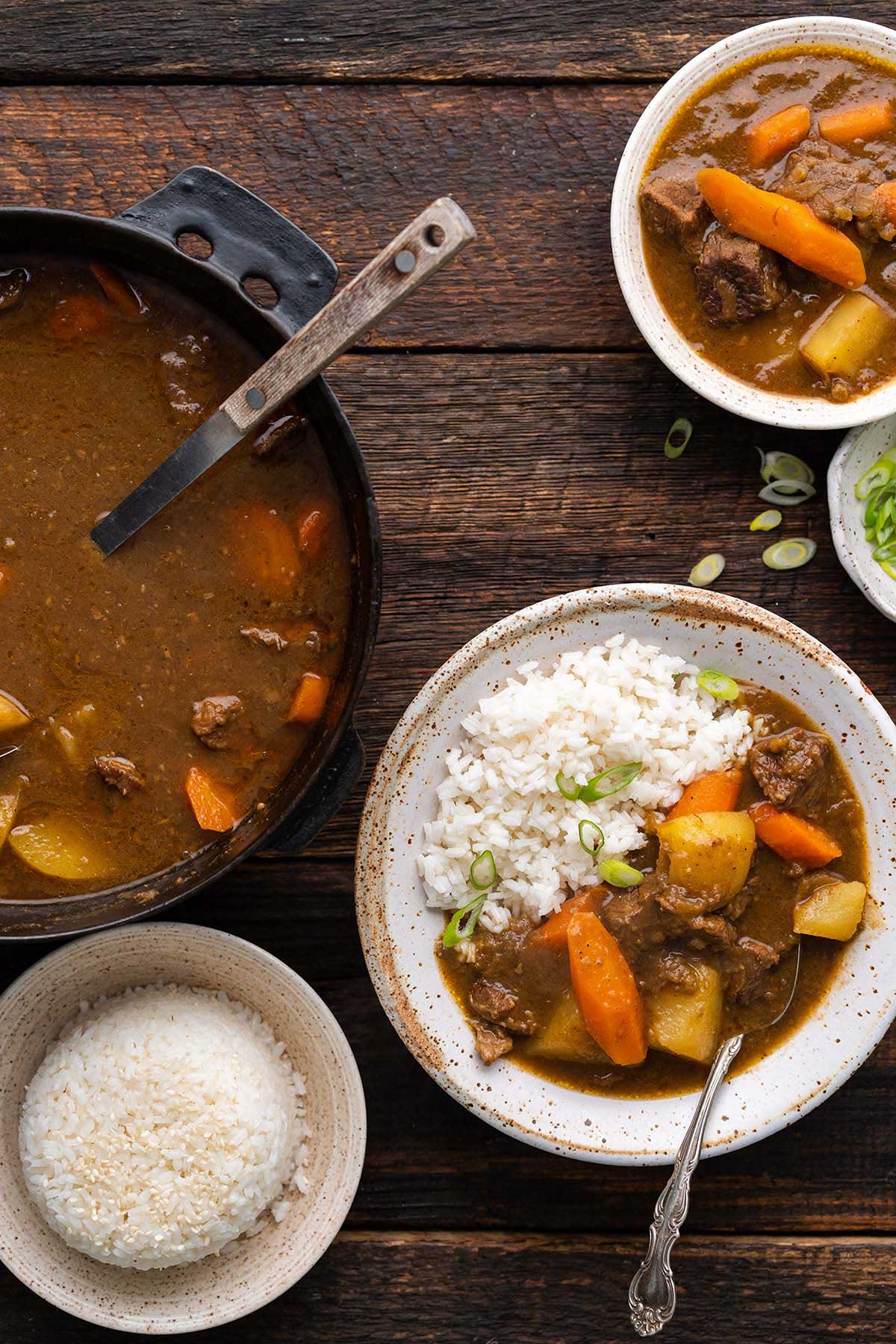 top view of rustic table with steamed rice and Japanese beef curry