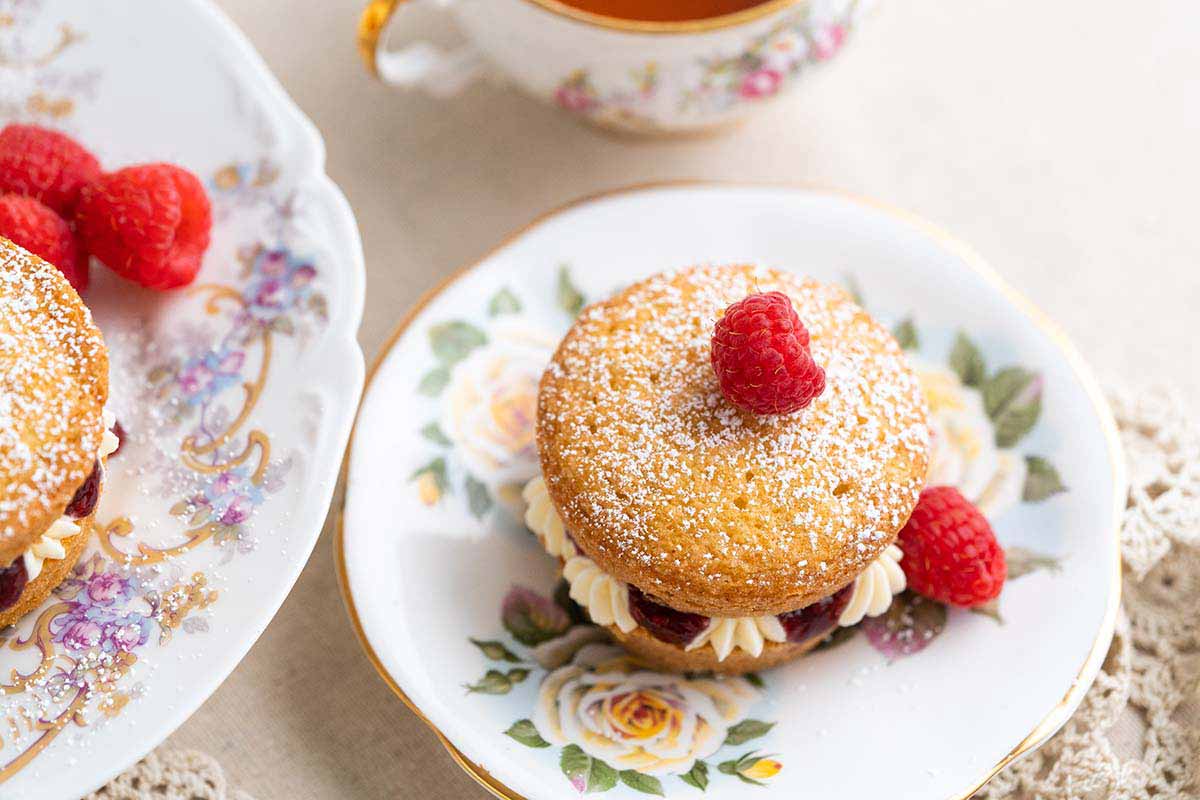 individual Victoria sandwich cake on fancy china for tea time