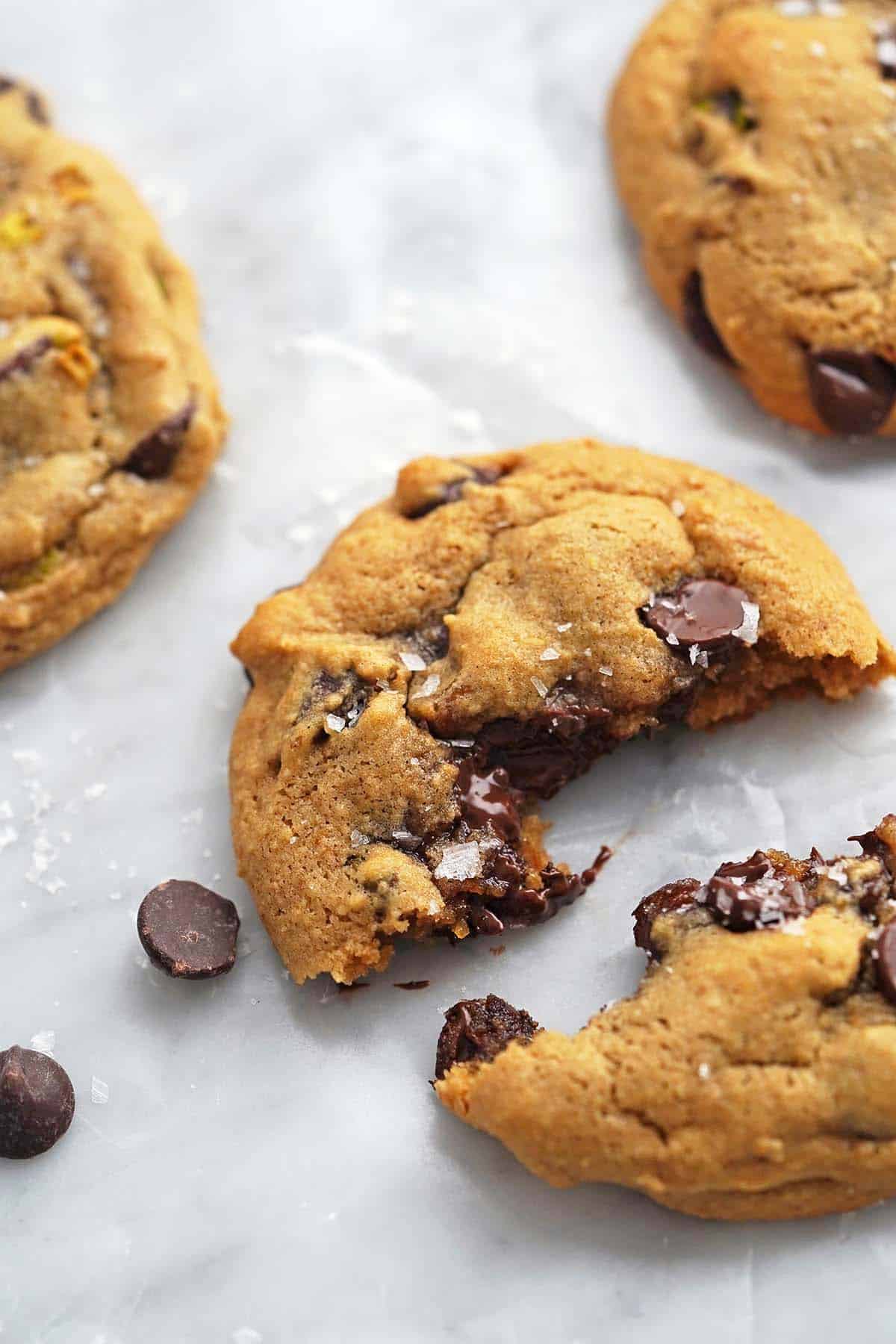breaking chewy grain free chocolate chip cookie in half