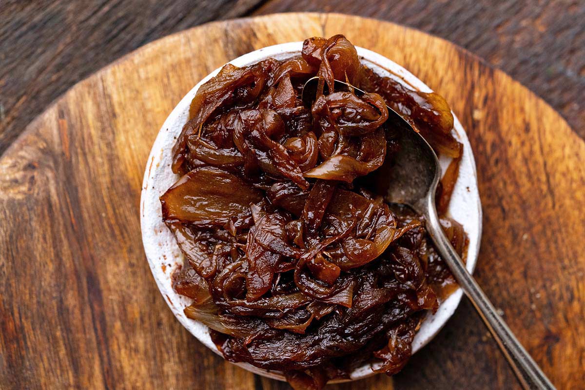 caramelized onions in white dish on wooden board