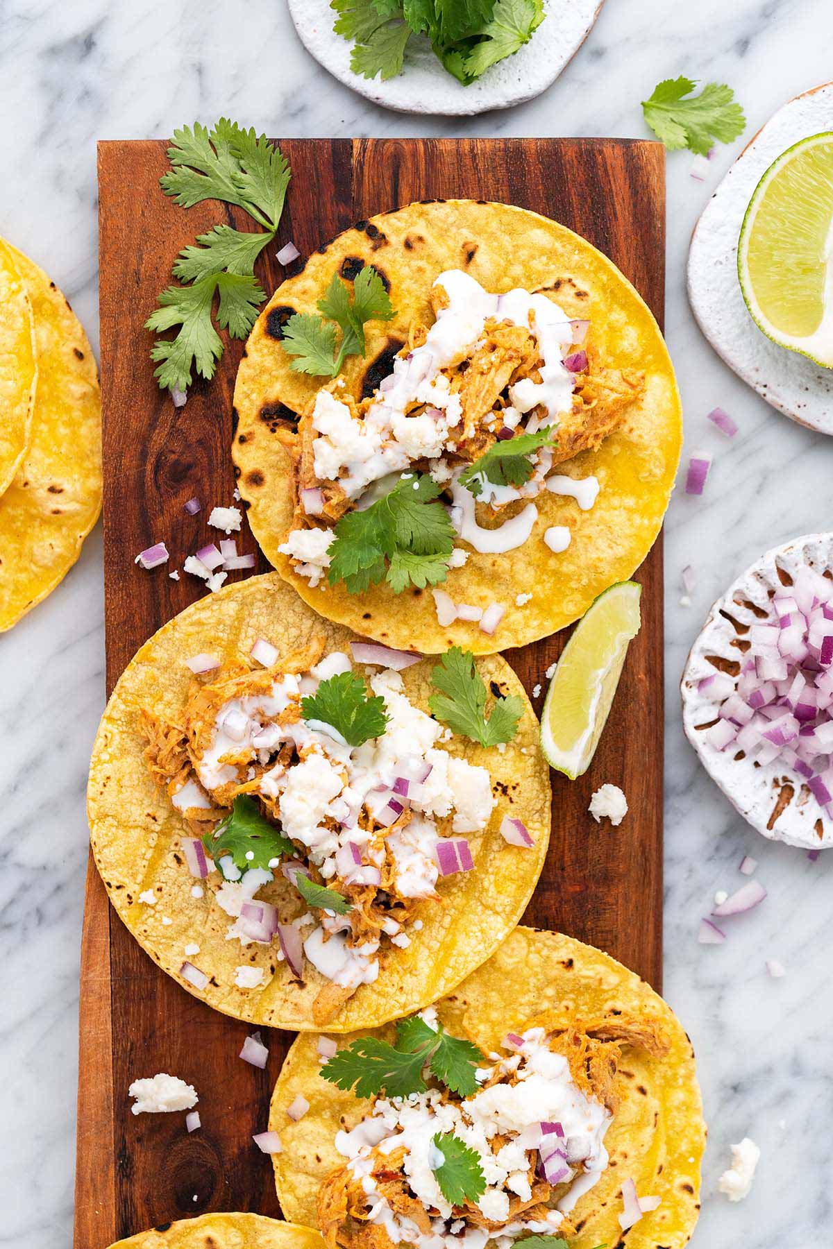 creamy chipotle chicken tacos on wooden serving platter
