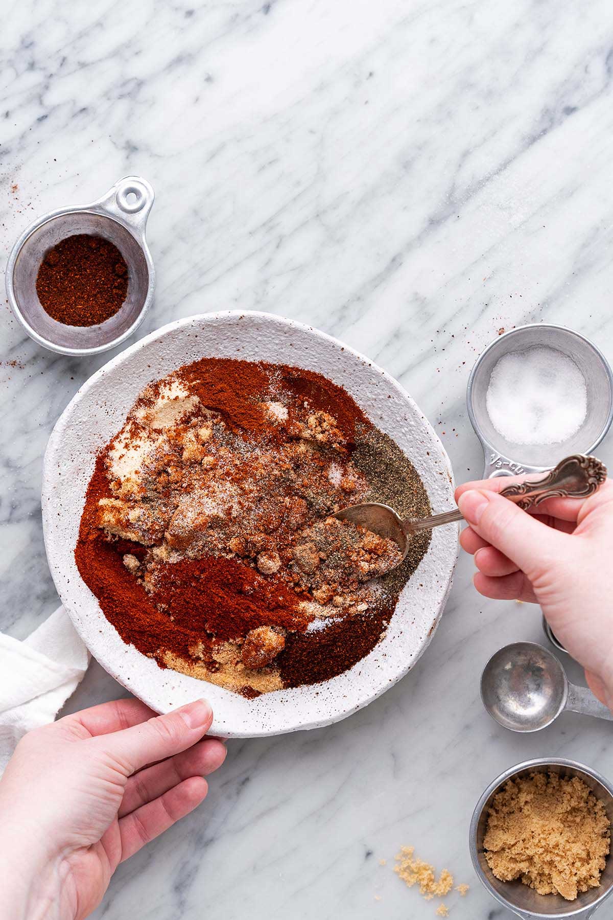 mixing spices for barbeque seasoning blend