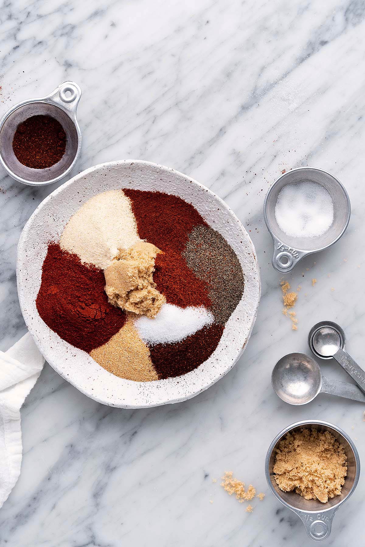 stoneware bowl with spices for bbq seasoning before mixing