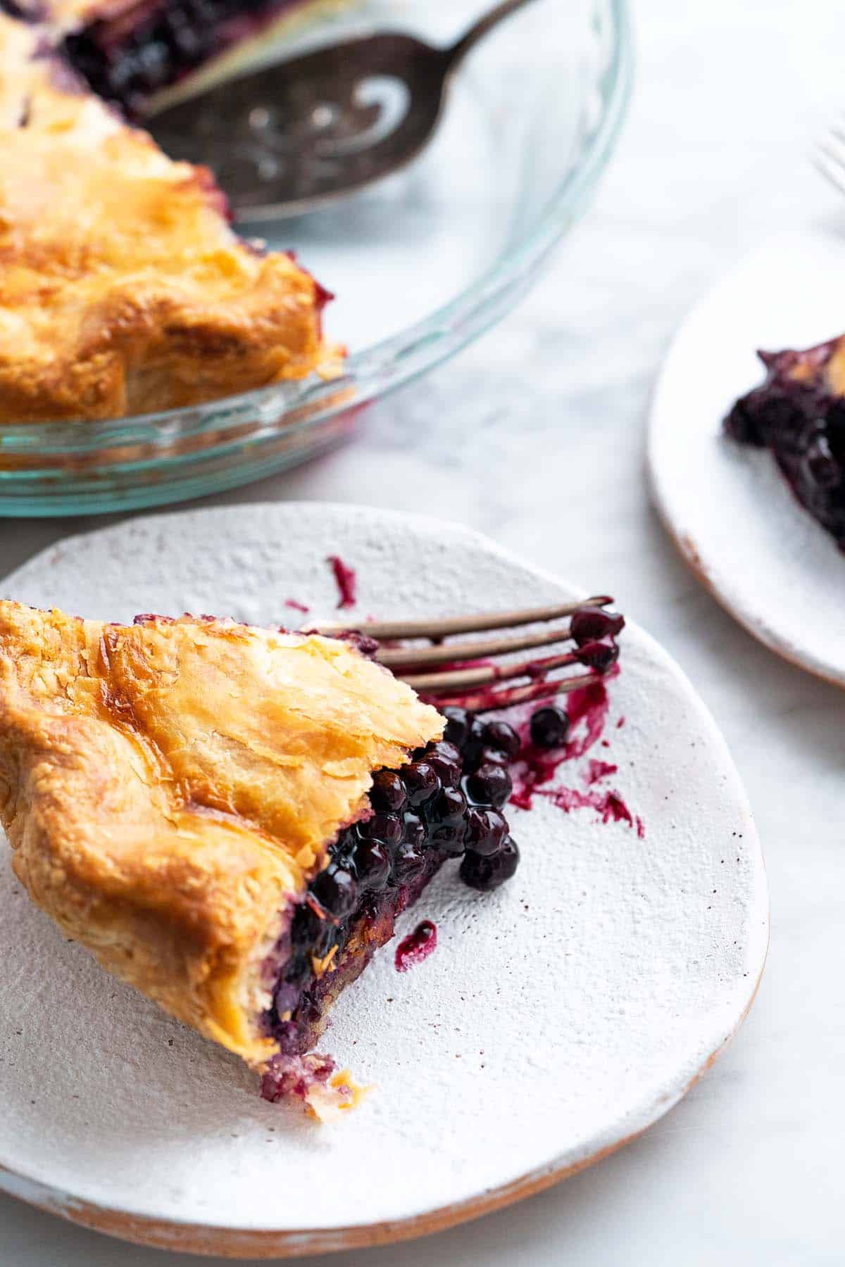 slices of blueberry pie on stoneware plates