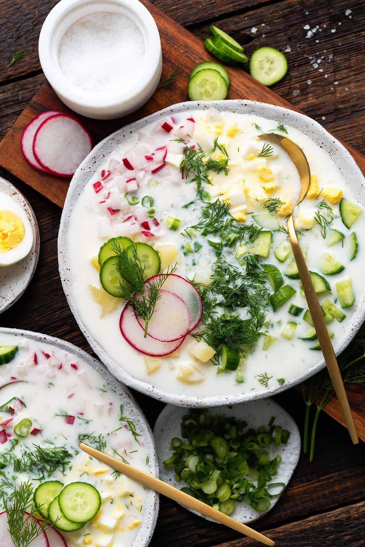 top view of spread of okroshka with fresh vegetables and kefir