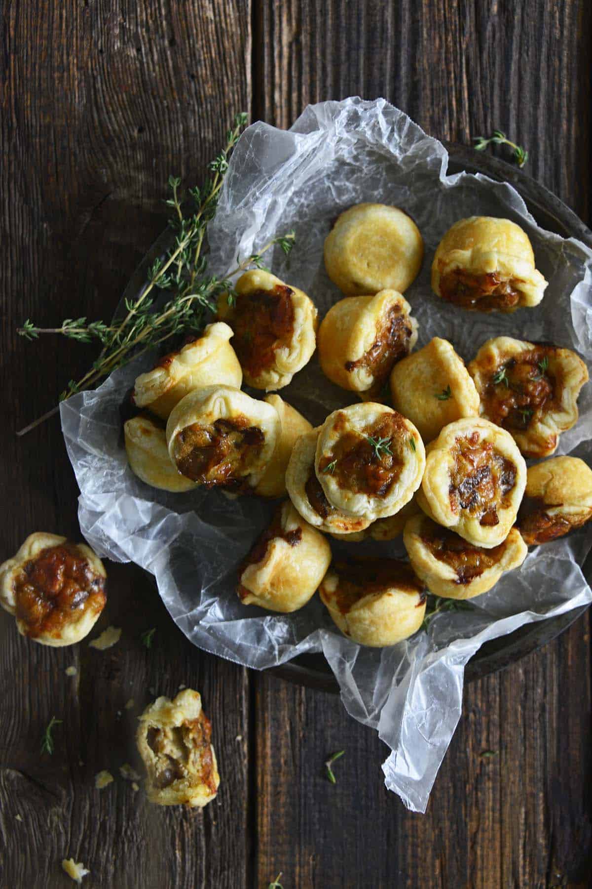 caramelized onion tartlets in dish on dark wooden table