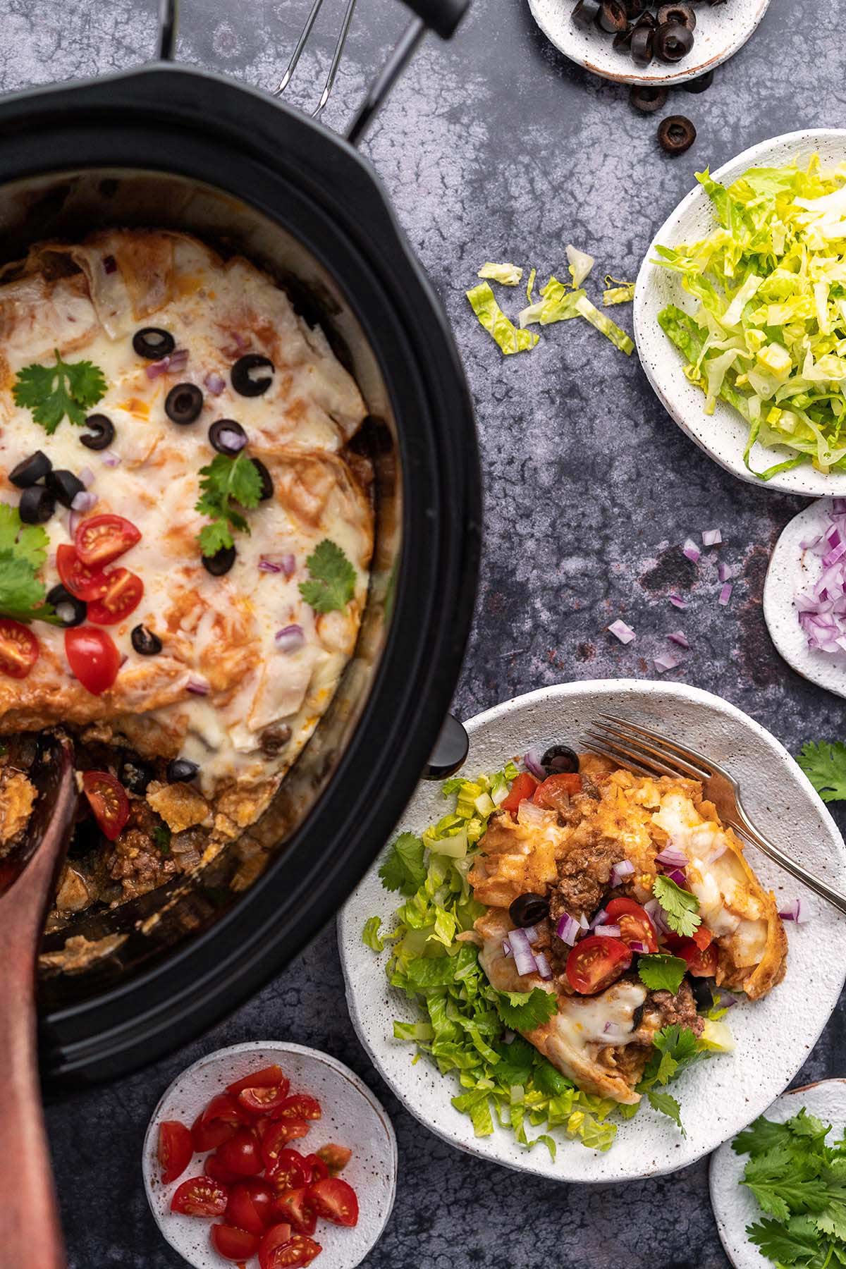 crockpot enchiladas with toppings and plated serving