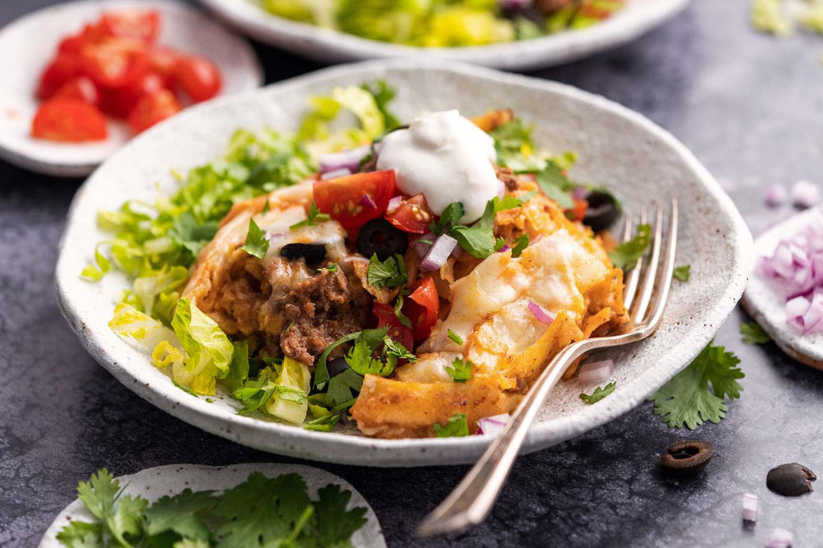 enchilada casserole serving in white bowl