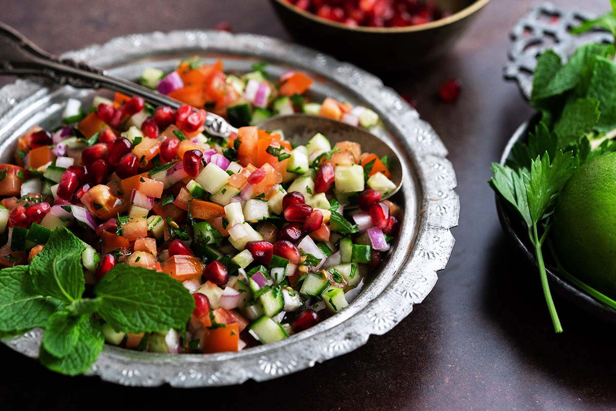 iranian salad with chopped vegetables and pomegranate