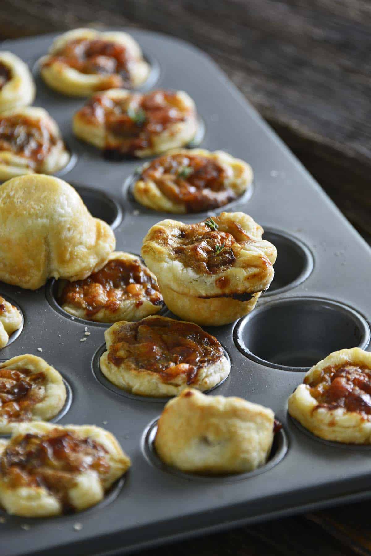 mini muffin tray with caramelized onion tartlets
