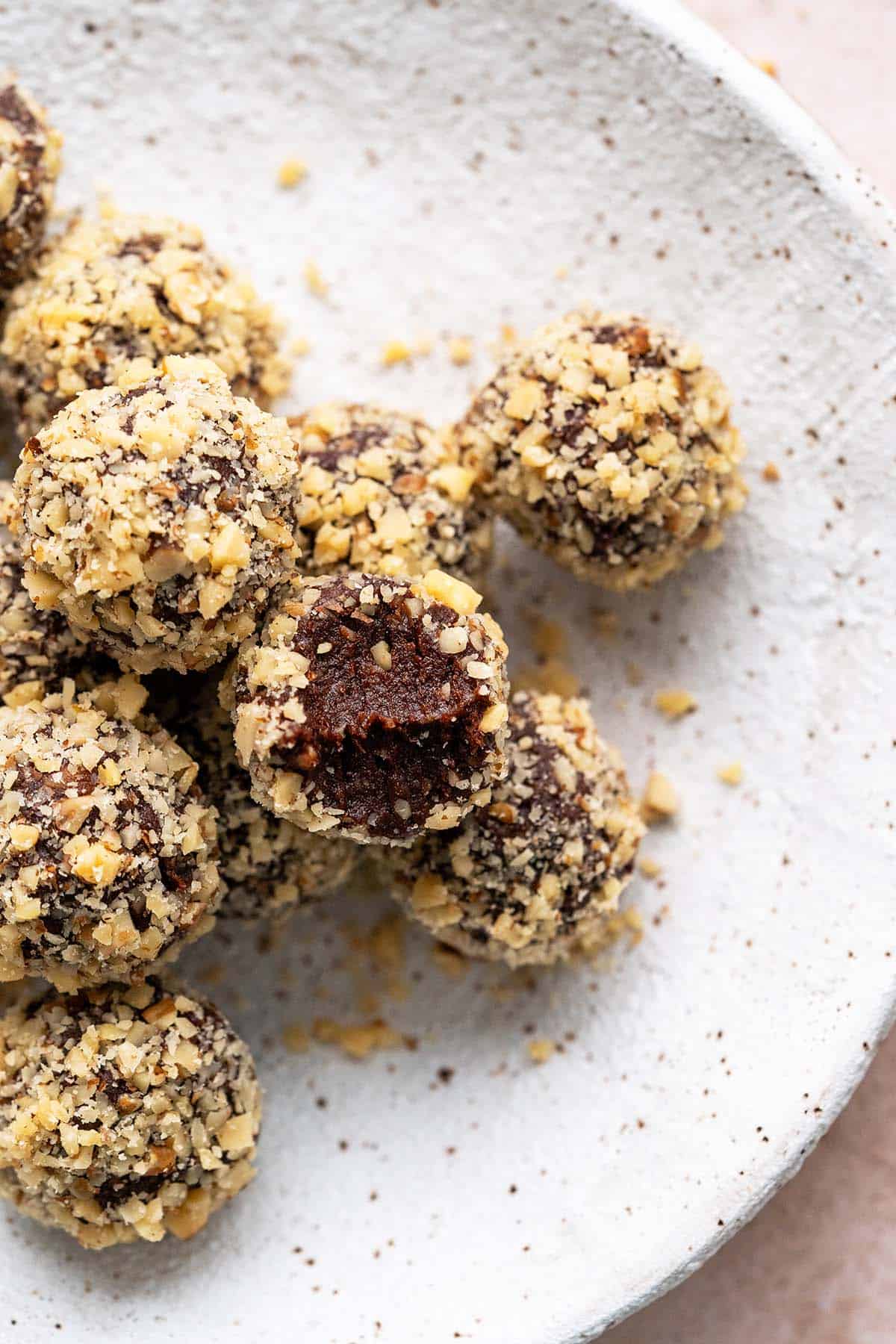 overhead view of healthy vegan chocolate date balls in stoneware bowl