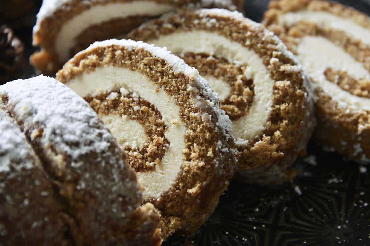 slices of gingerbread cake roll with maple frosting swirl filling