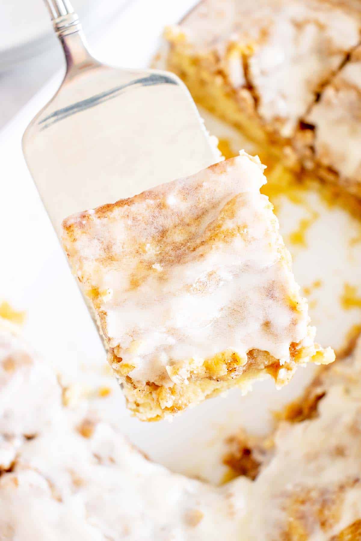 spatula holding piece of honeybun cake