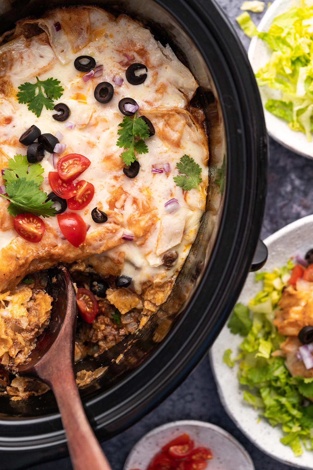 top view of ground beef crockpot enchiladas in slow cooker