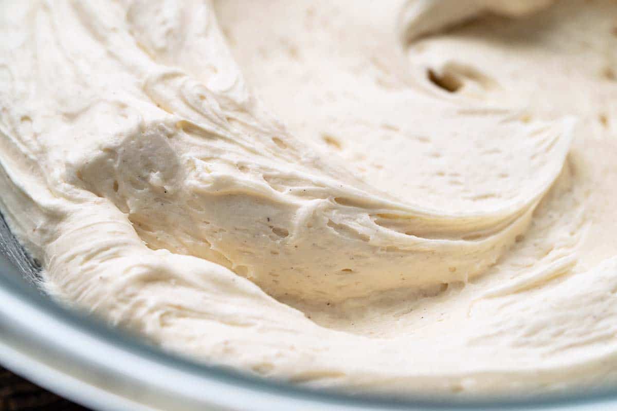 close up of vanilla frosting in bowl
