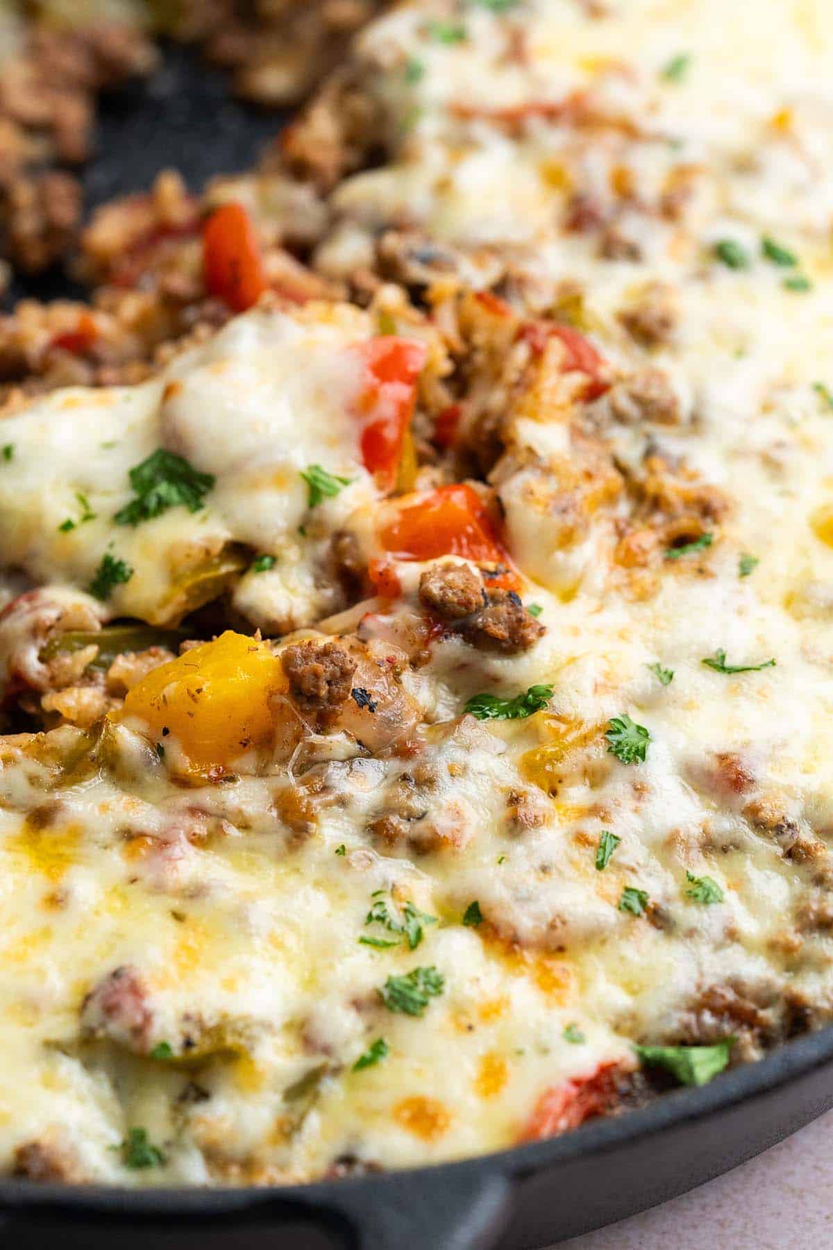close up view of stuffed pepper casserole in skillet showing ground beef and cheese